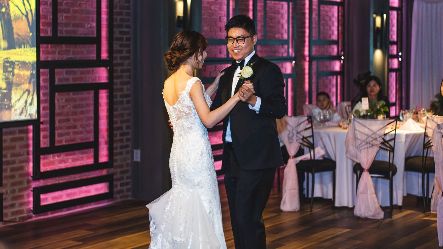 A newlywed couple having their first dance.
