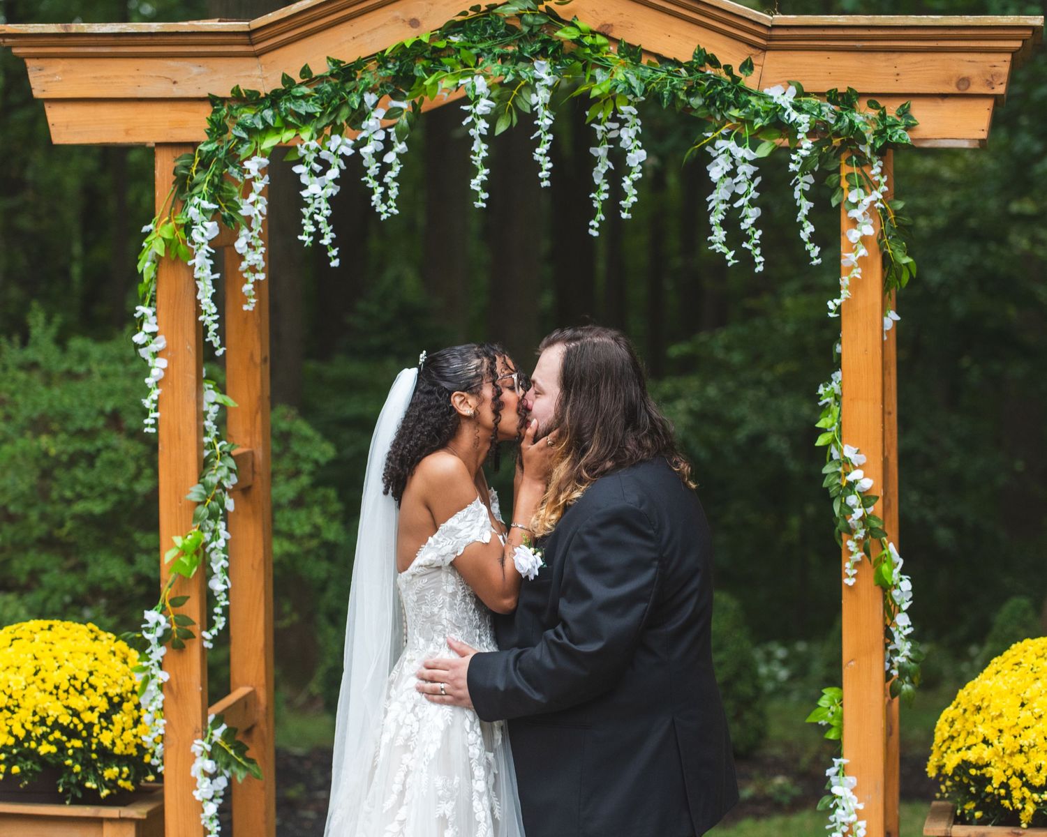 A newlywed couple kissing.
