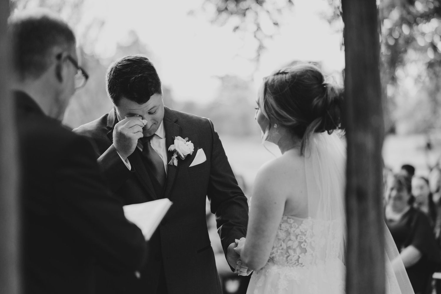 A black and white wedding photo collage showing intimate moments between a bride and groom in an outdoor setting.