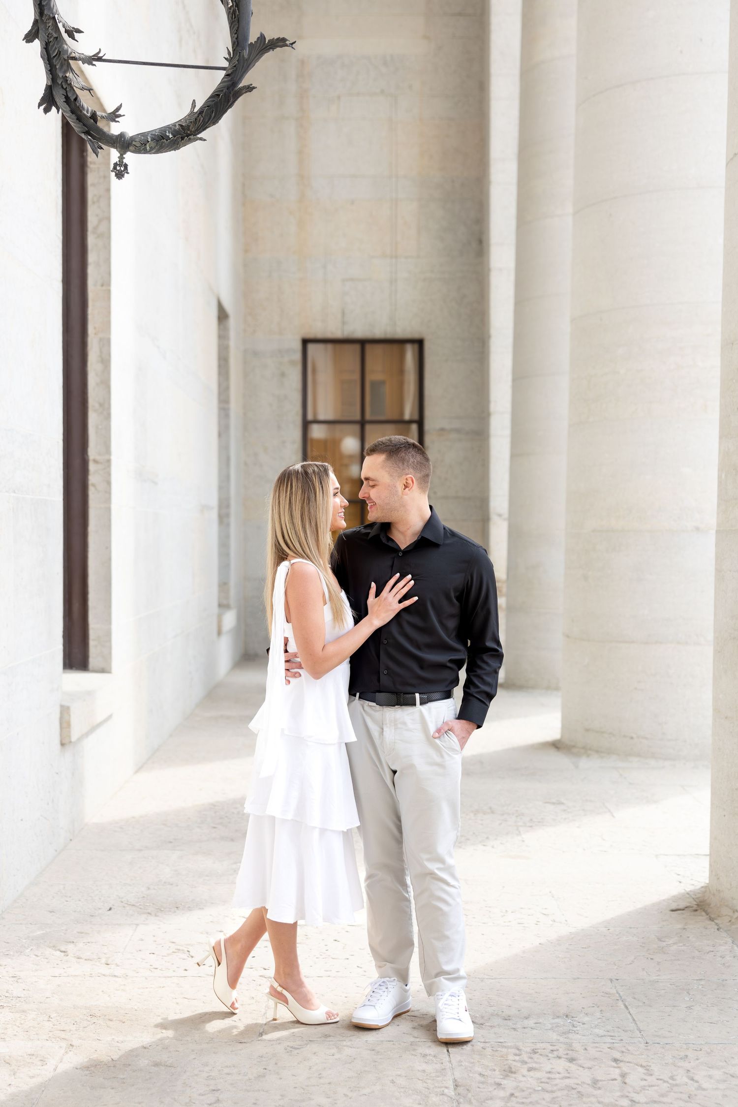 Light and airy engagement photos of a joyful couple at the Ohio Statehouse in downtown Columbus, Ohio captured by Julia and Sean Photography
