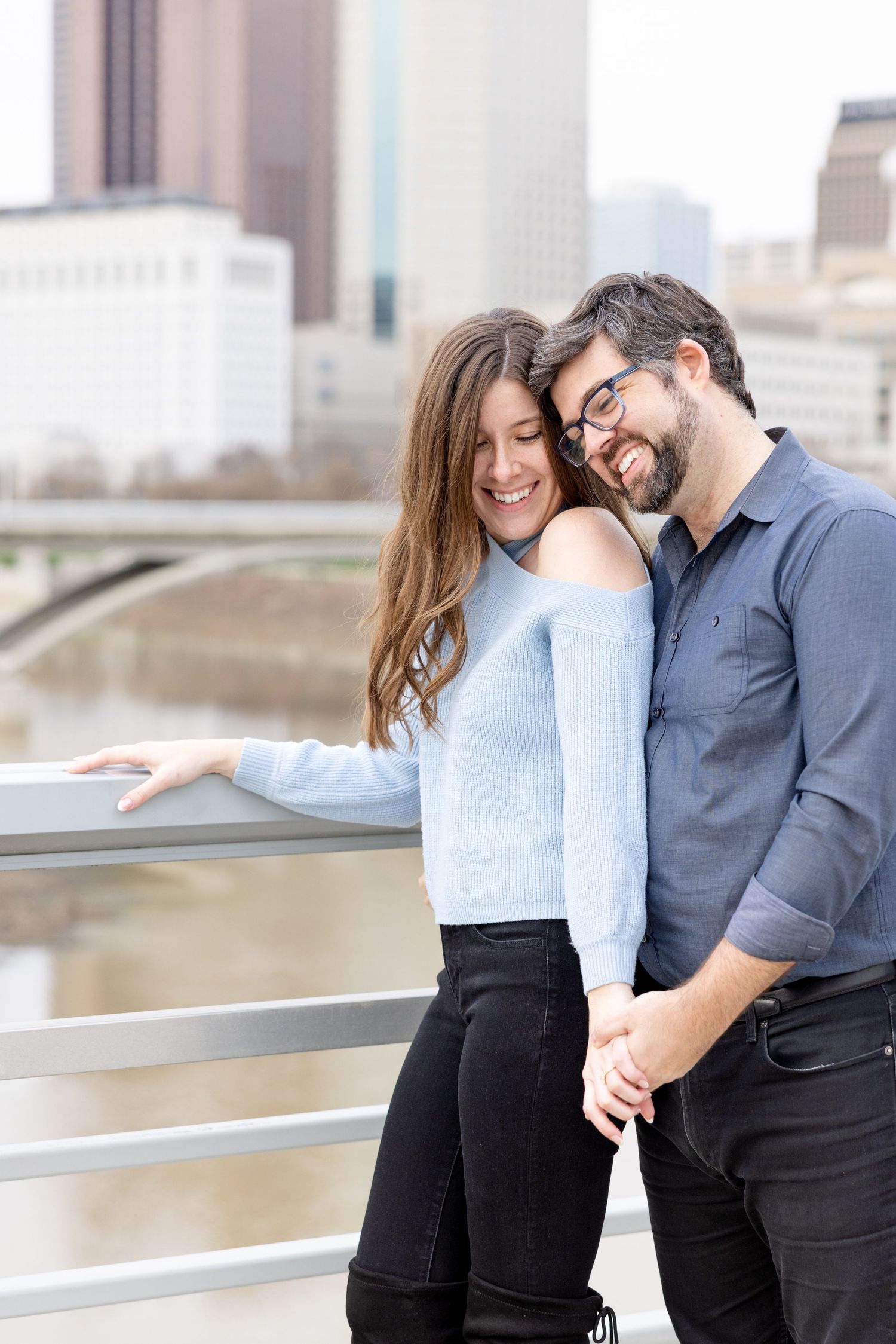 Downtown Columbus engagement photos on Main Street Bridge with a joyful couple in a light and airy style