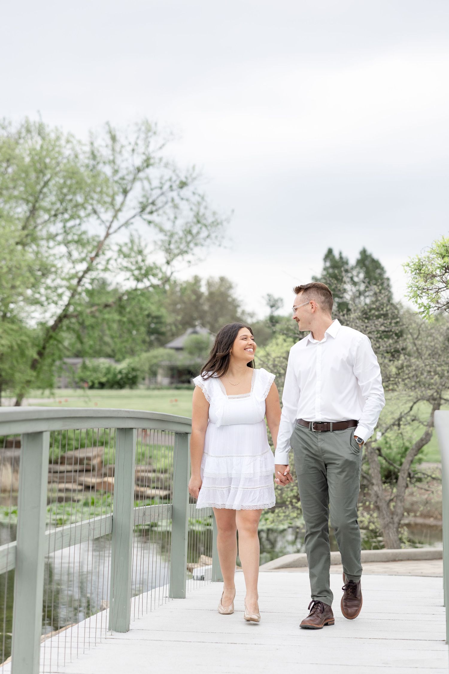 Engaged couple laughing together at Cox Arboretum in Dayton, Ohio during a joyful garden engagement session