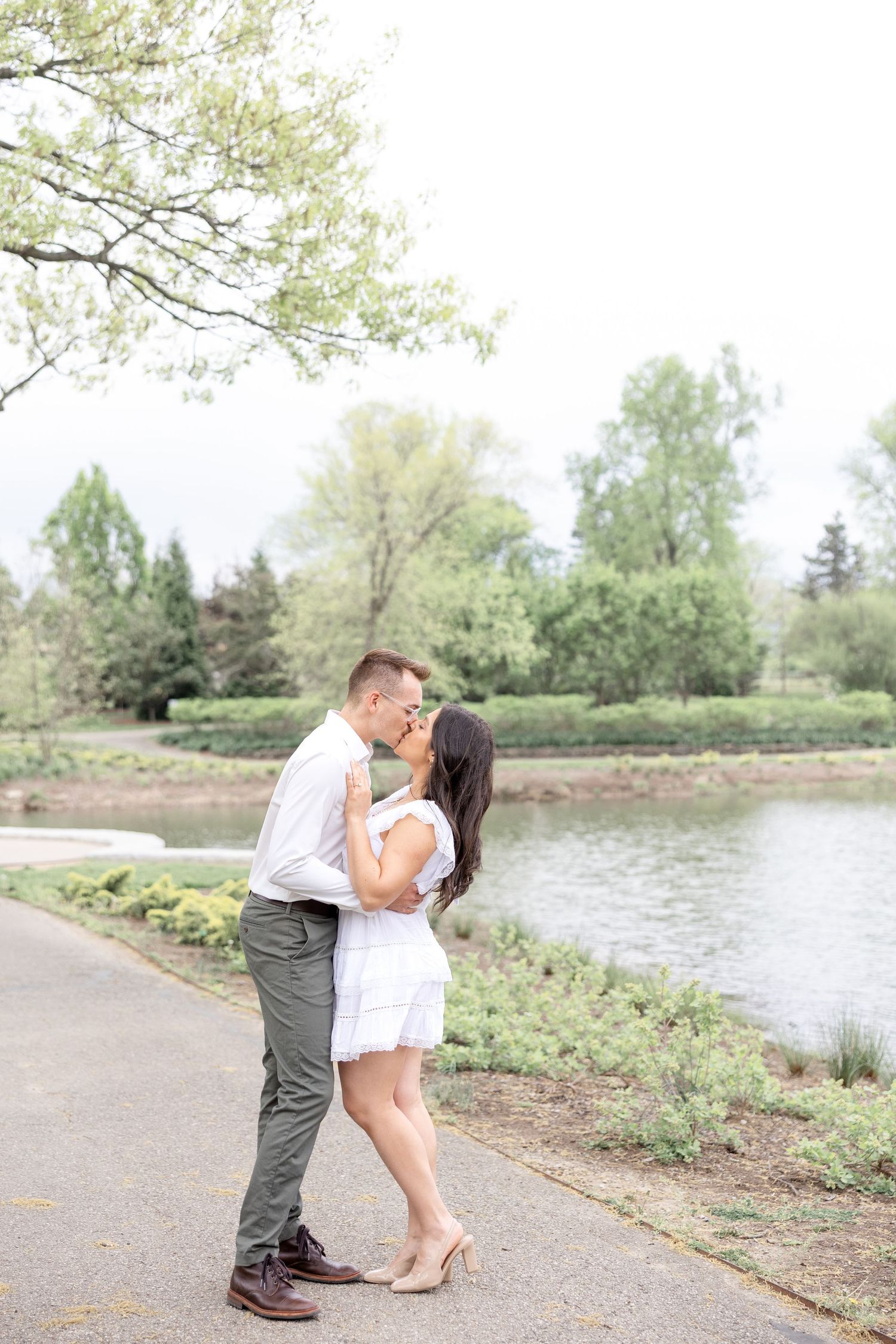 Engaged couple laughing together at Cox Arboretum in Dayton, Ohio during a joyful garden engagement session