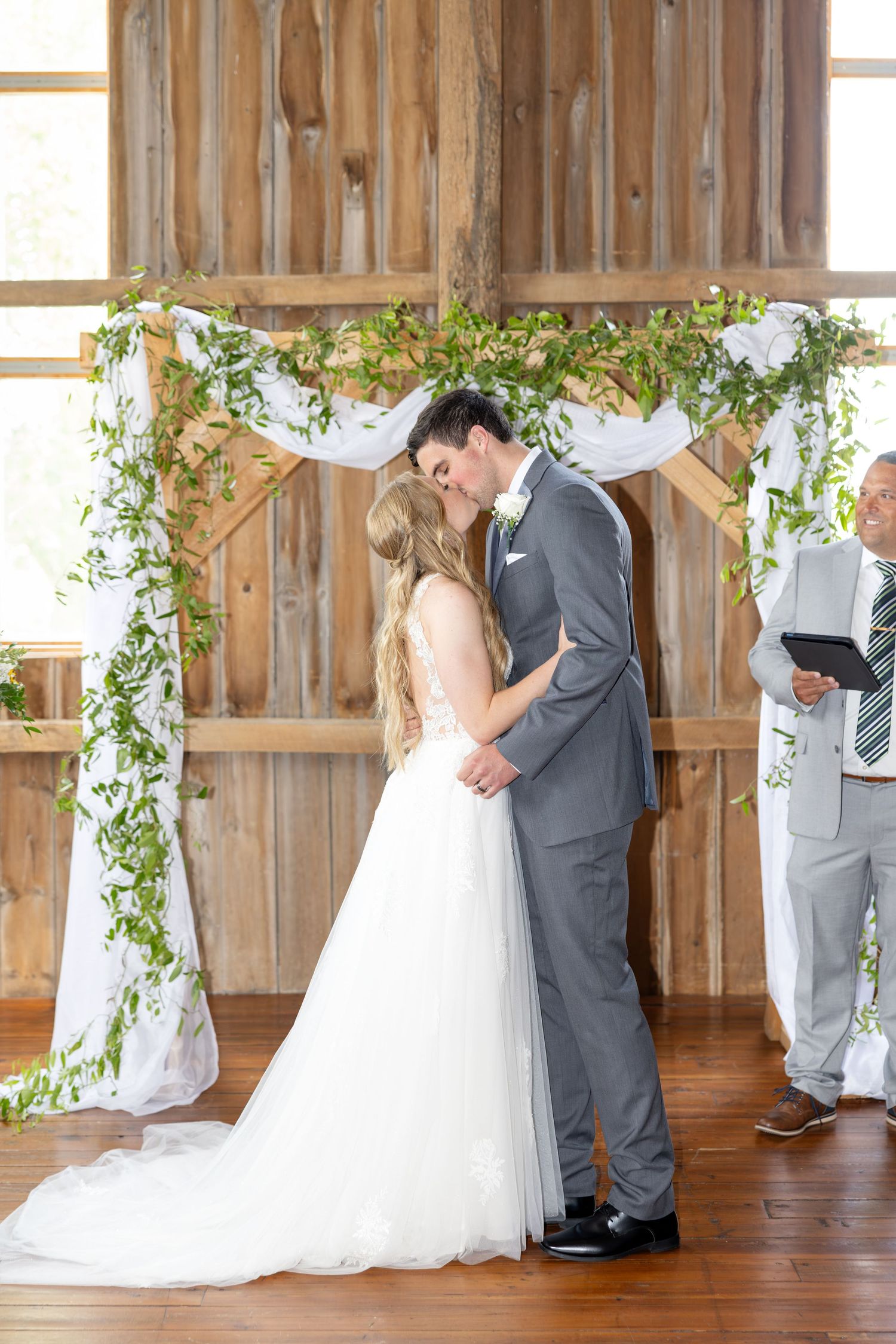 Timeless wedding photography at The Bicentennial Barn in Dayton, Ohio, featuring a joyful Cedarville University couple on their wedding day.