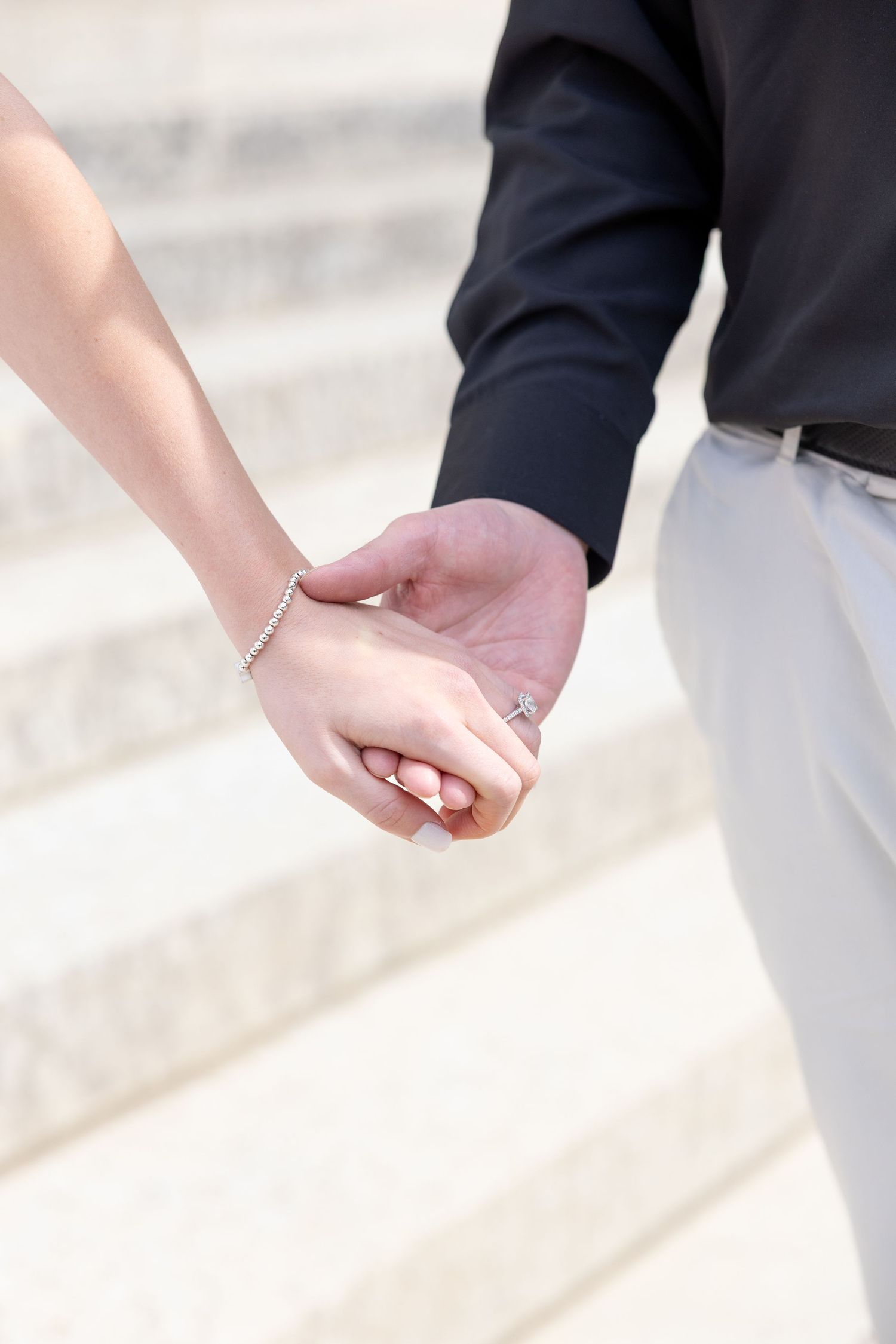 Light and airy engagement photos of a joyful couple at the Ohio Statehouse in downtown Columbus, Ohio captured by Julia and Sean Photography