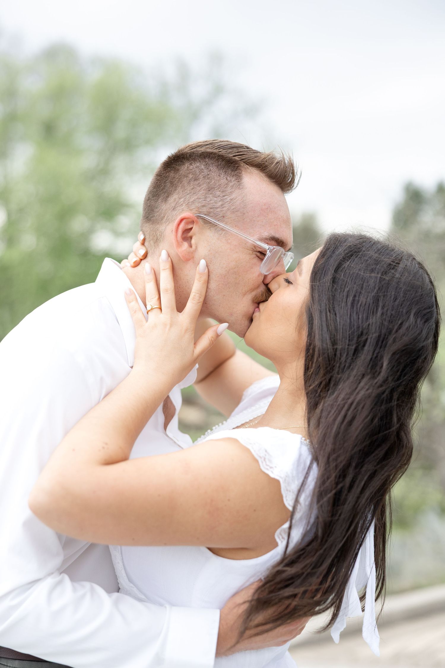 Engaged couple laughing together at Cox Arboretum in Dayton, Ohio during a joyful garden engagement session