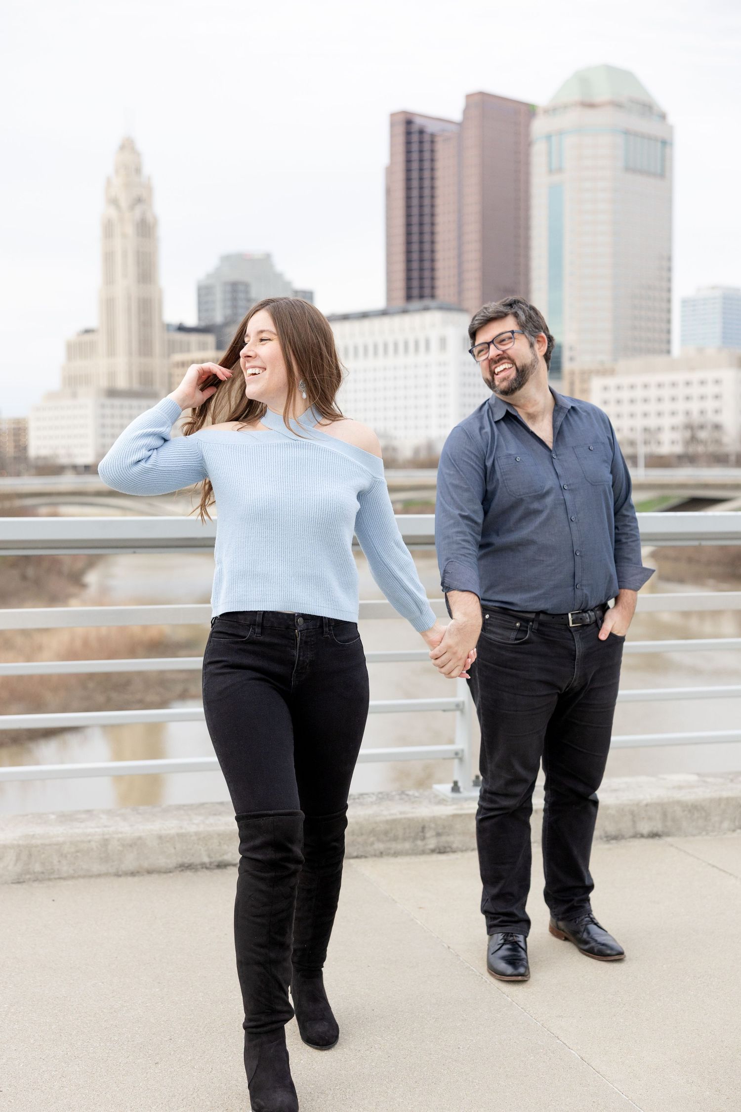 Downtown Columbus engagement photos on Main Street Bridge with a joyful couple in a light and airy style