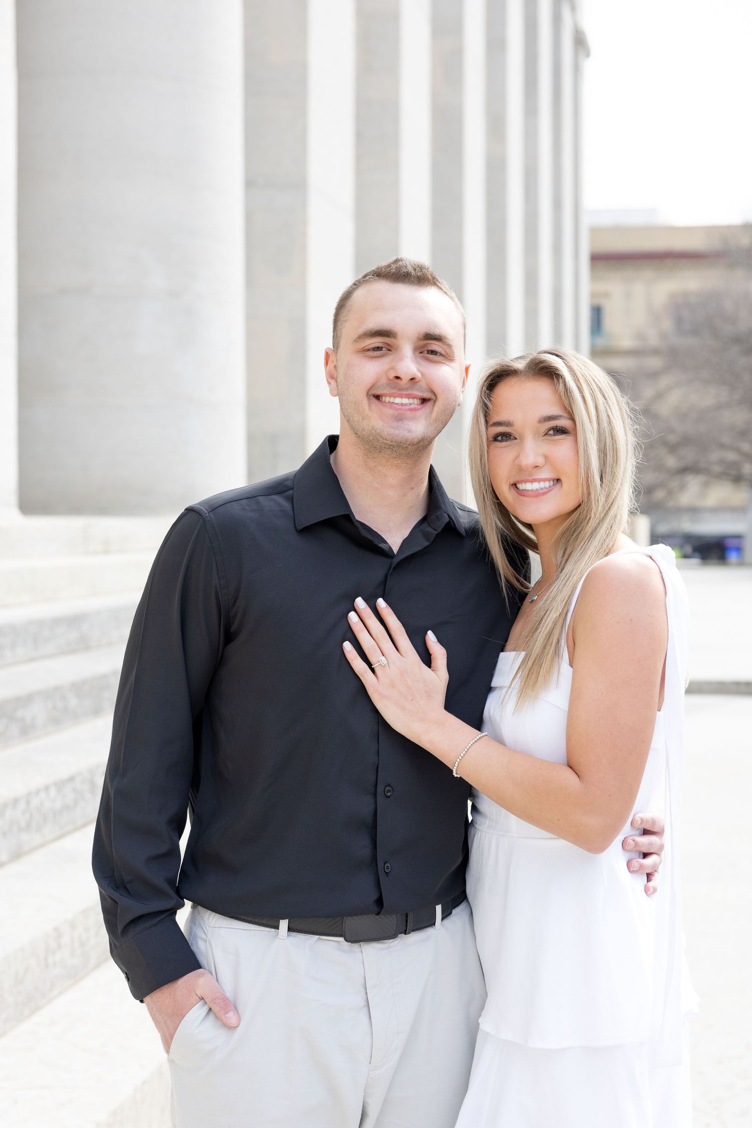 Light and airy engagement photos of a joyful couple at the Ohio Statehouse in downtown Columbus, Ohio captured by Julia and Sean Photography