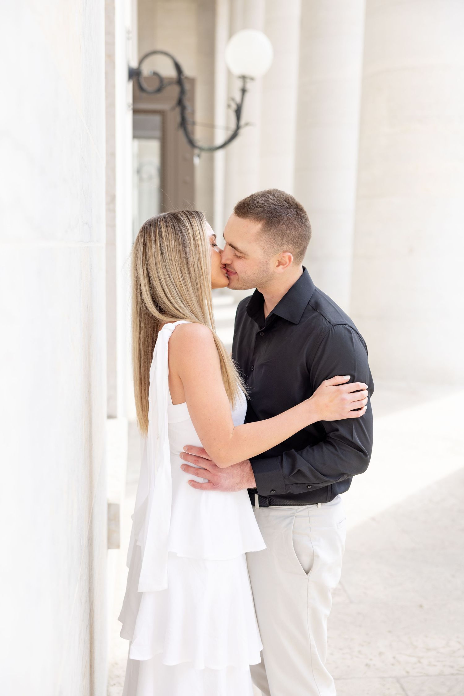 Light and airy engagement photos of a joyful couple at the Ohio Statehouse in downtown Columbus, Ohio captured by Julia and Sean Photography