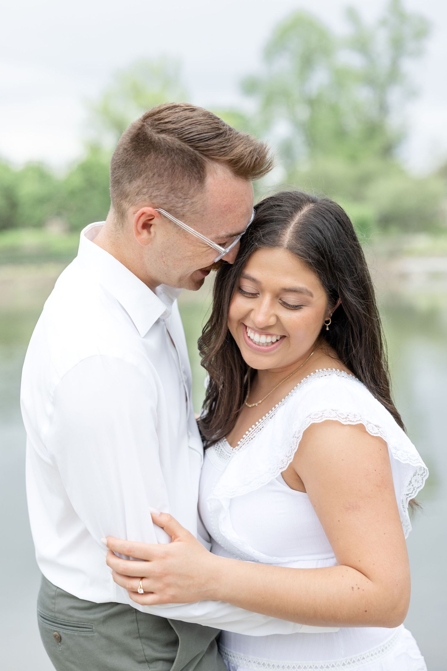 Engaged couple laughing together at Cox Arboretum in Dayton, Ohio during a joyful garden engagement session