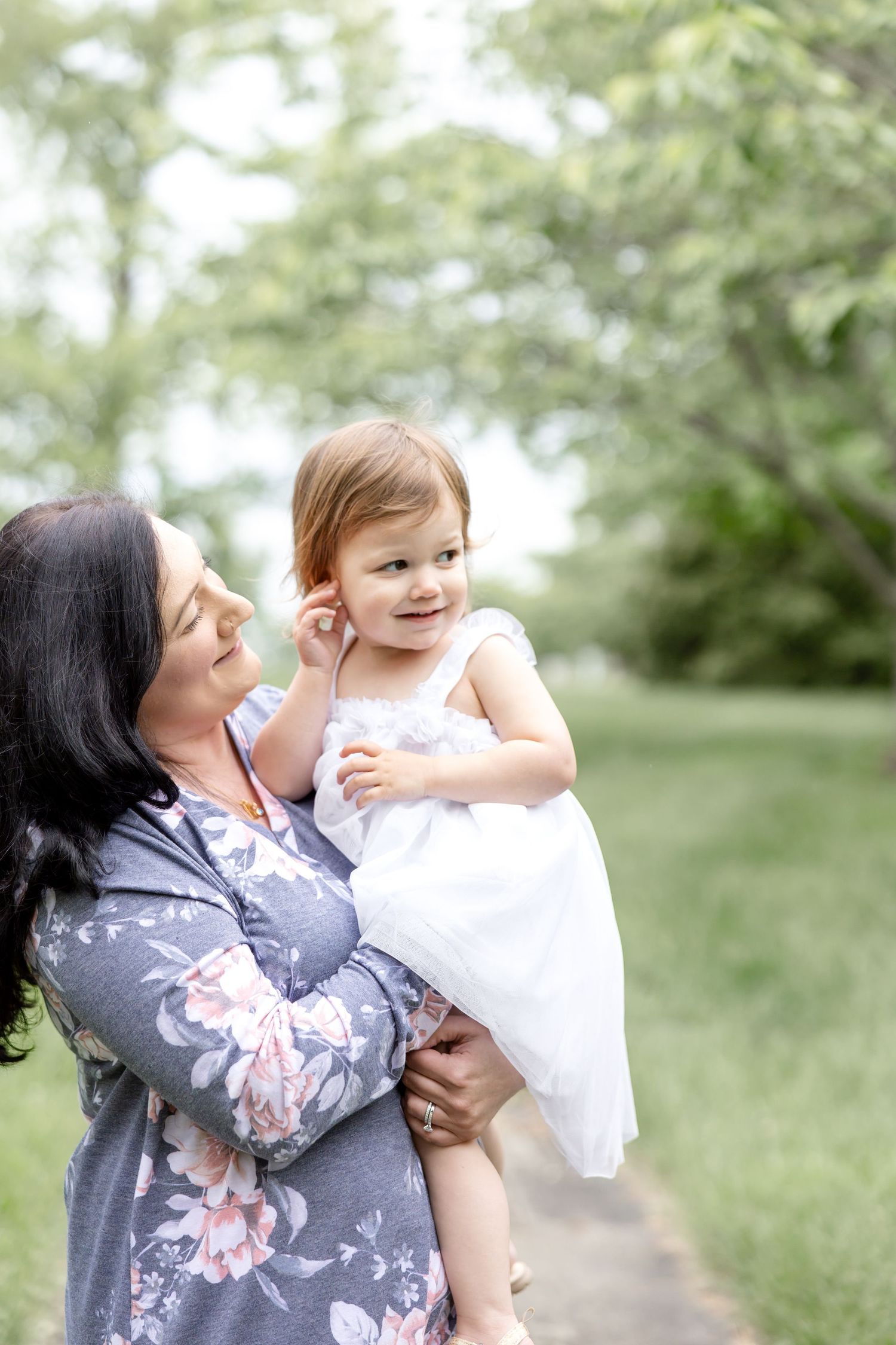Mother holding her baby during a timeless motherhood session at Carillon Park in Dayton Ohio with Julia and Sean Photography