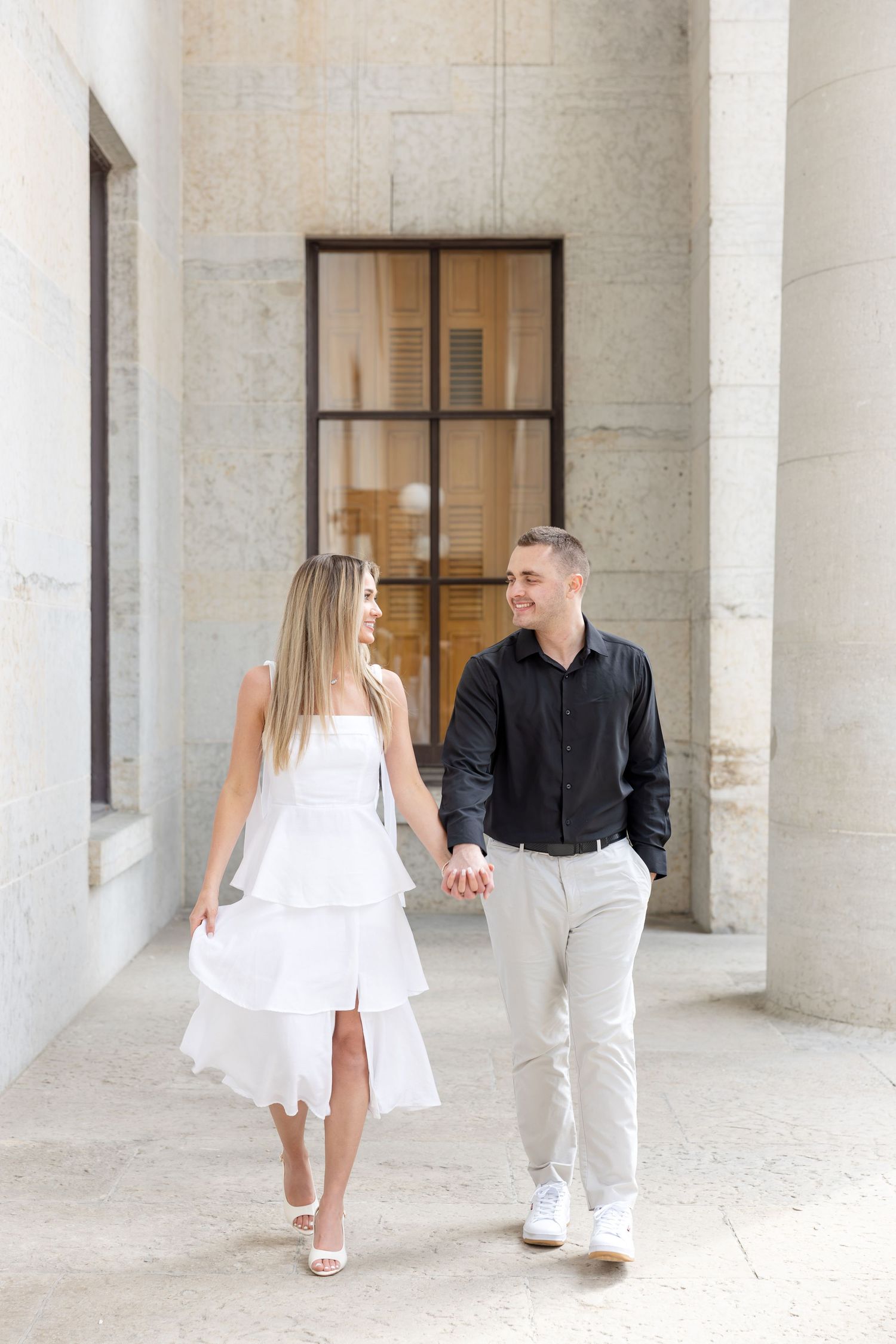 Light and airy engagement photos of a joyful couple at the Ohio Statehouse in downtown Columbus, Ohio captured by Julia and Sean Photography