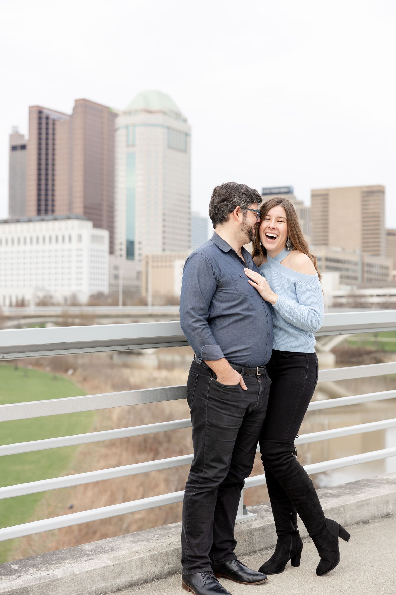 Downtown Columbus engagement photos on Main Street Bridge with a joyful couple in a light and airy style