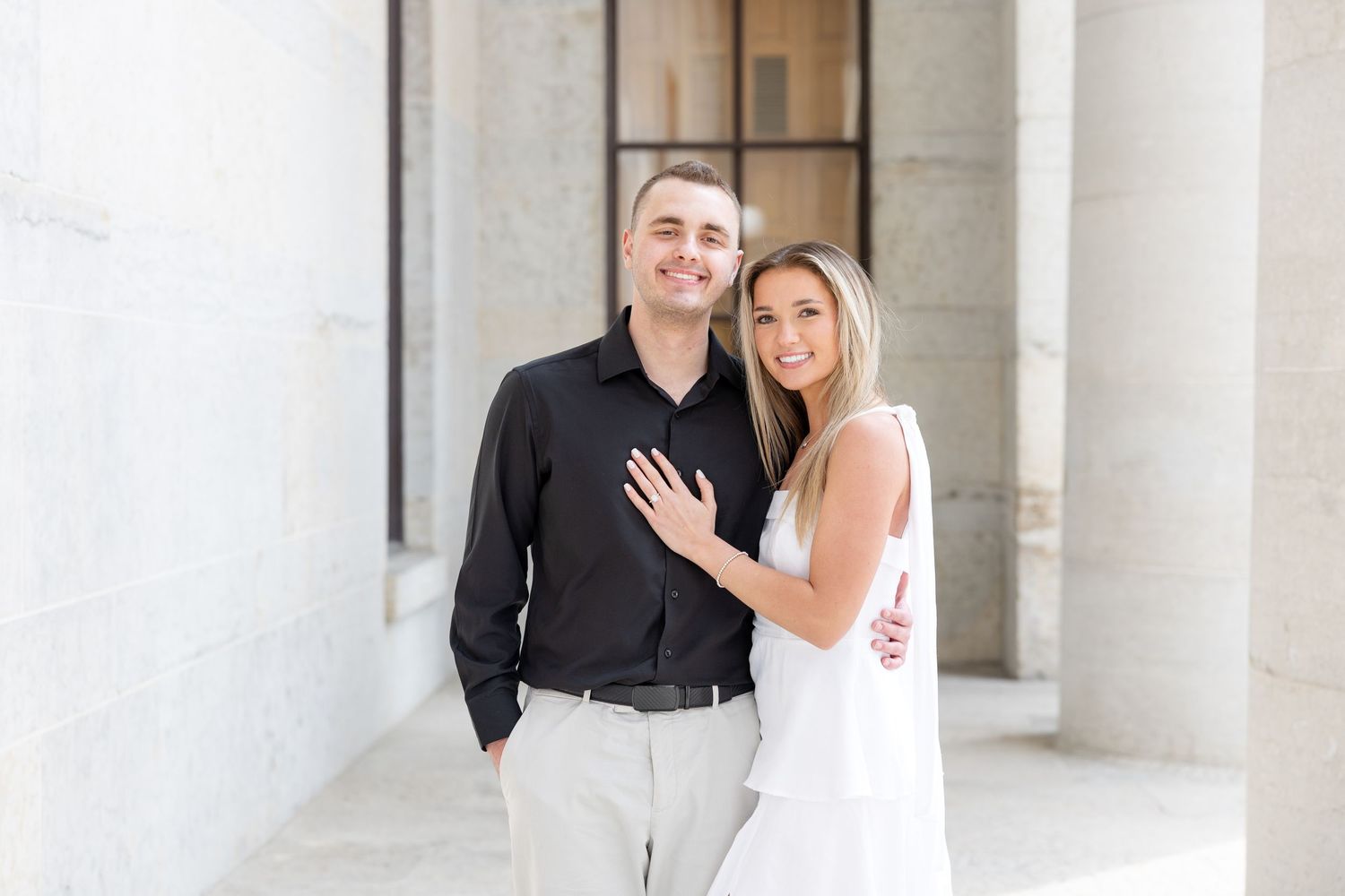 Light and airy engagement photos of a joyful couple at the Ohio Statehouse in downtown Columbus, Ohio captured by Julia and Sean Photography