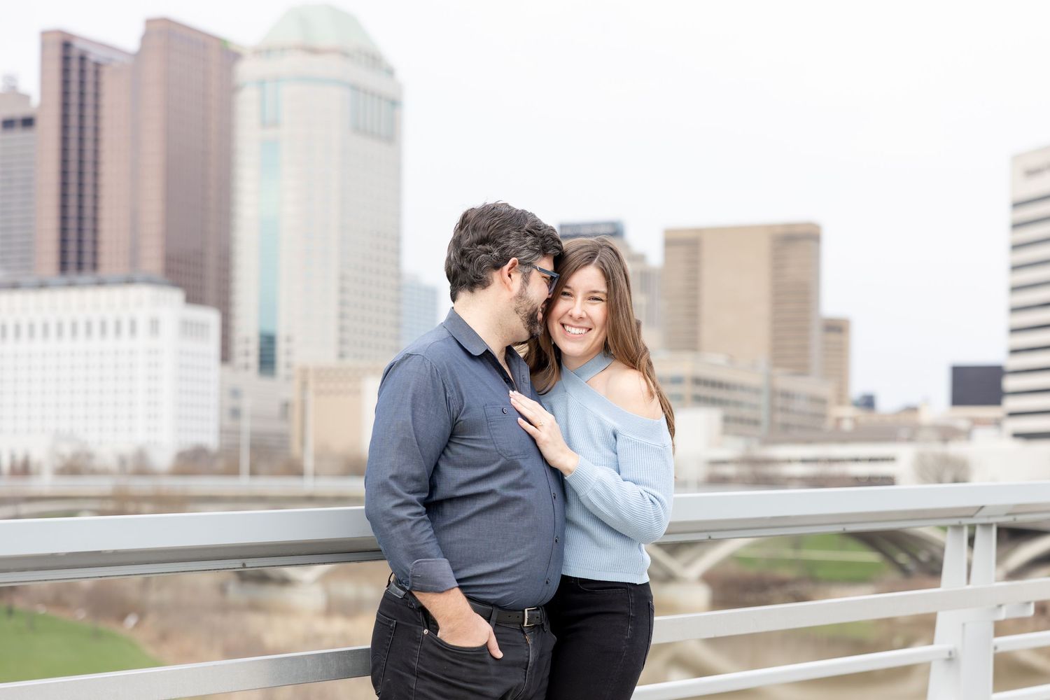 Downtown Columbus engagement photos on Main Street Bridge with a joyful couple in a light and airy style