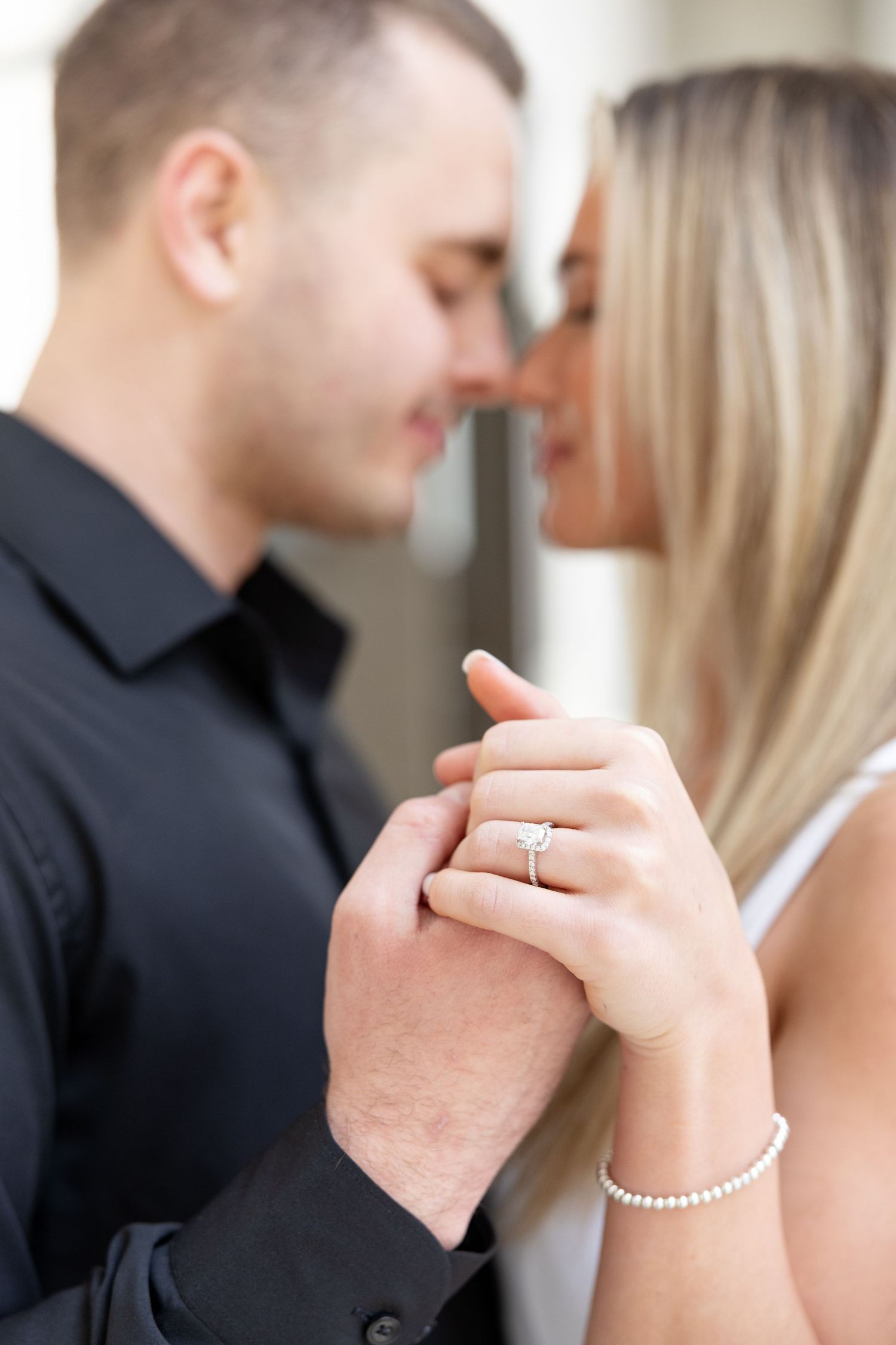Light and airy engagement photos of a joyful couple at the Ohio Statehouse in downtown Columbus, Ohio captured by Julia and Sean Photography