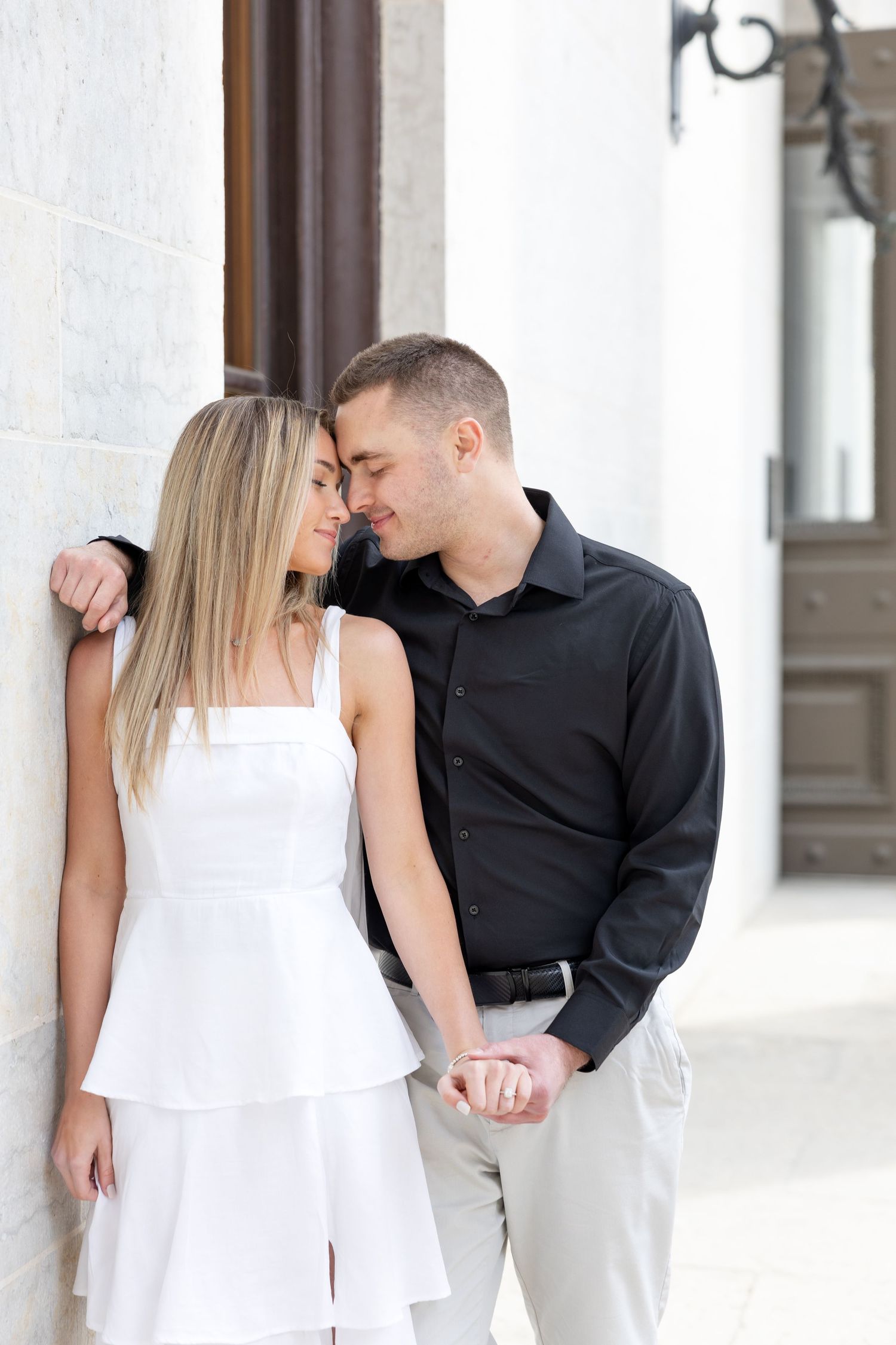 Light and airy engagement photos of a joyful couple at the Ohio Statehouse in downtown Columbus, Ohio captured by Julia and Sean Photography