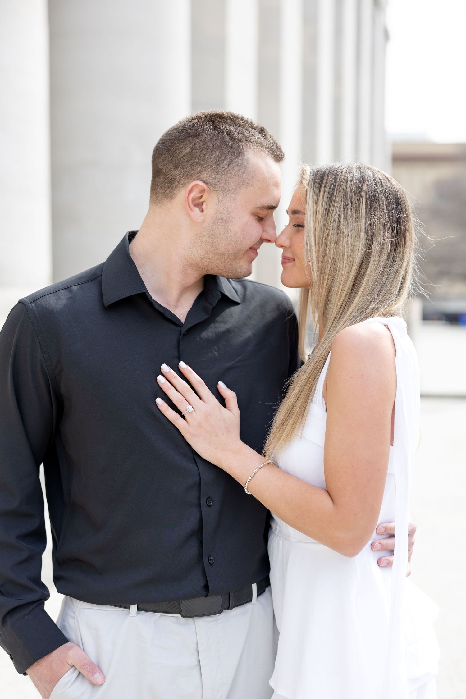 Light and airy engagement photos of a joyful couple at the Ohio Statehouse in downtown Columbus, Ohio captured by Julia and Sean Photography