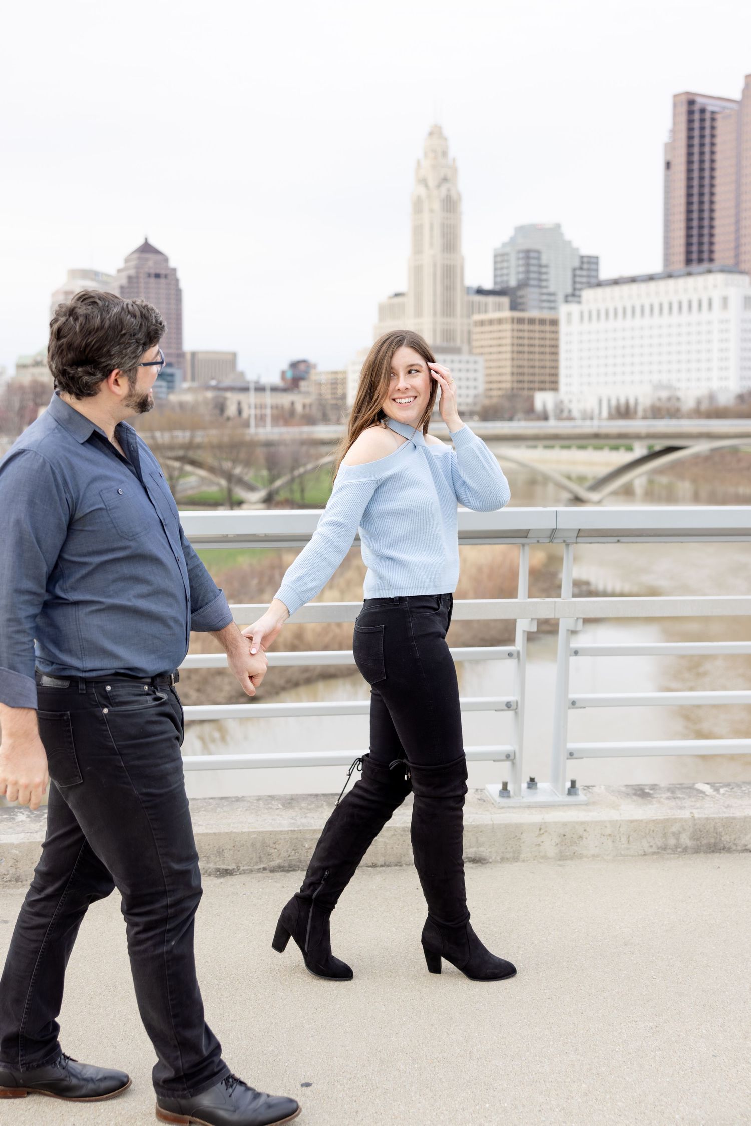 Downtown Columbus engagement photos on Main Street Bridge with a joyful couple in a light and airy style