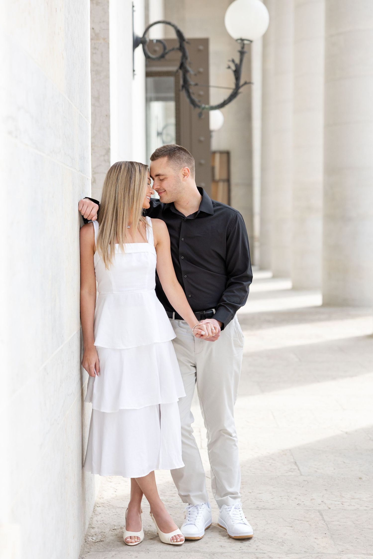 Light and airy engagement photos of a joyful couple at the Ohio Statehouse in downtown Columbus, Ohio captured by Julia and Sean Photography