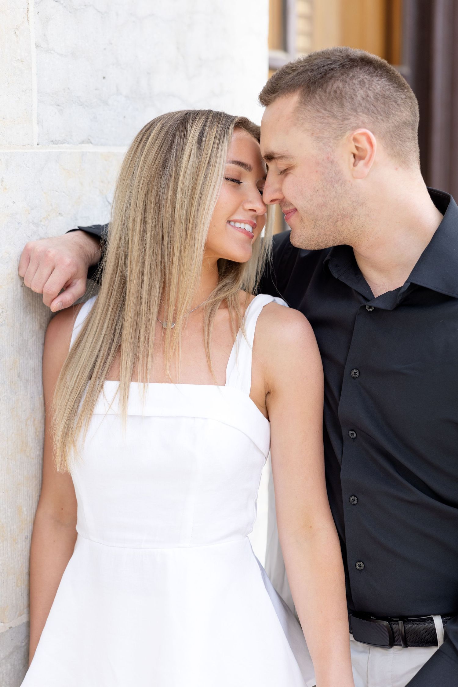 Light and airy engagement photos of a joyful couple at the Ohio Statehouse in downtown Columbus, Ohio captured by Julia and Sean Photography