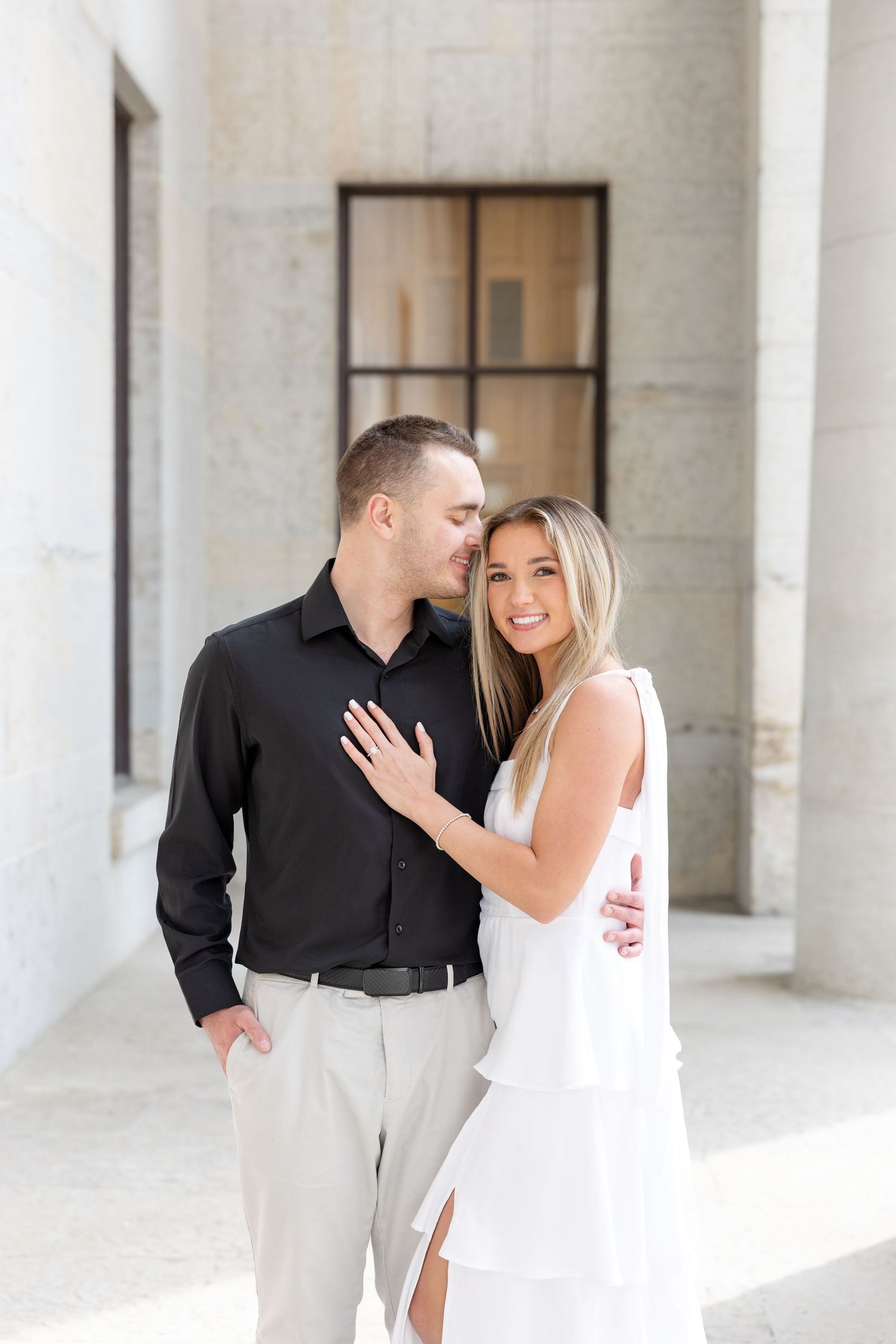 Light and airy engagement photos of a joyful couple at the Ohio Statehouse in downtown Columbus, Ohio captured by Julia and Sean Photography