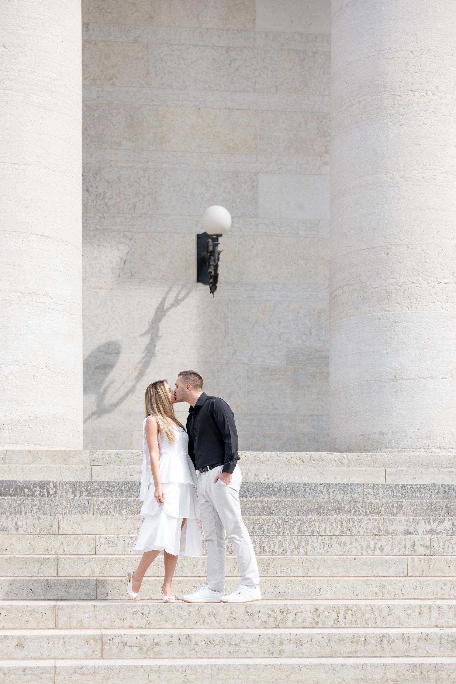 Light and airy engagement photos of a joyful couple at the Ohio Statehouse in downtown Columbus, Ohio captured by Julia and Sean Photography