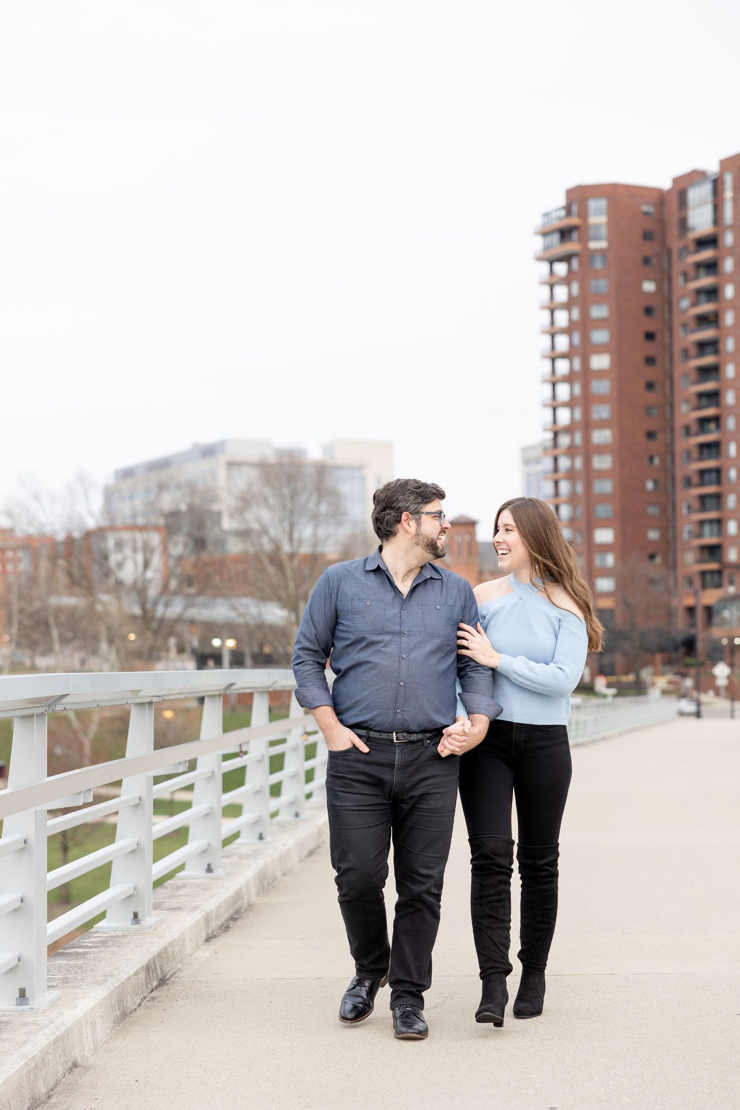Downtown Columbus engagement photos on Main Street Bridge with a joyful couple in a light and airy style