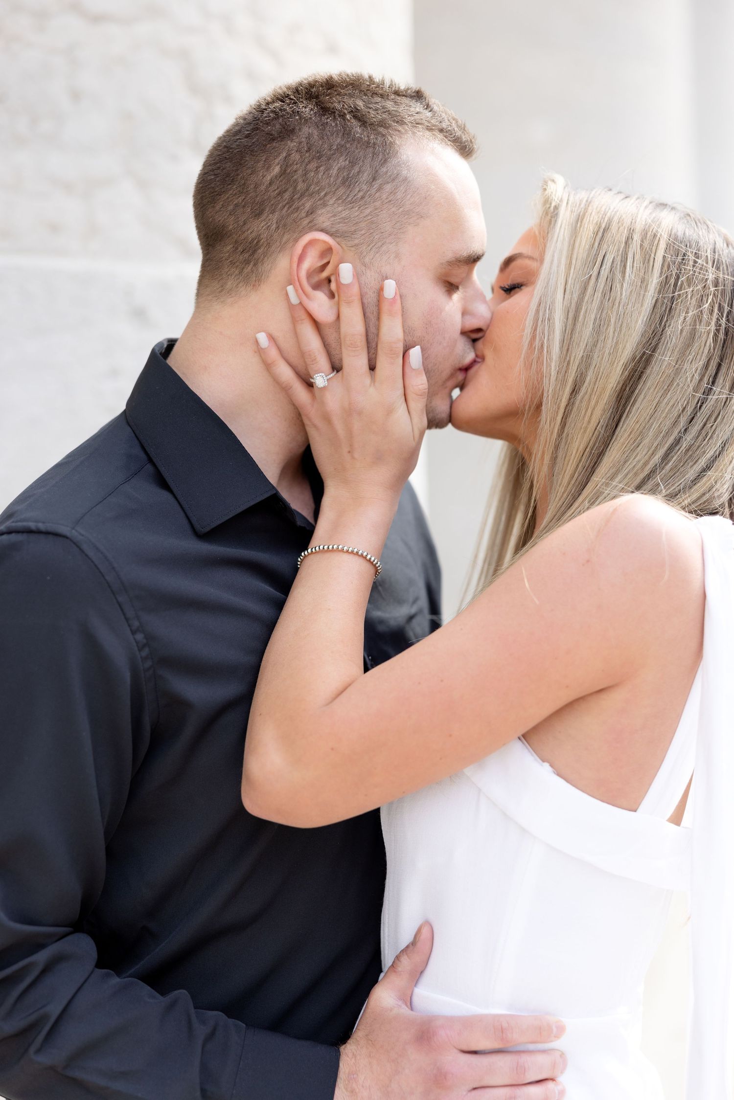 Light and airy engagement photos of a joyful couple at the Ohio Statehouse in downtown Columbus, Ohio captured by Julia and Sean Photography