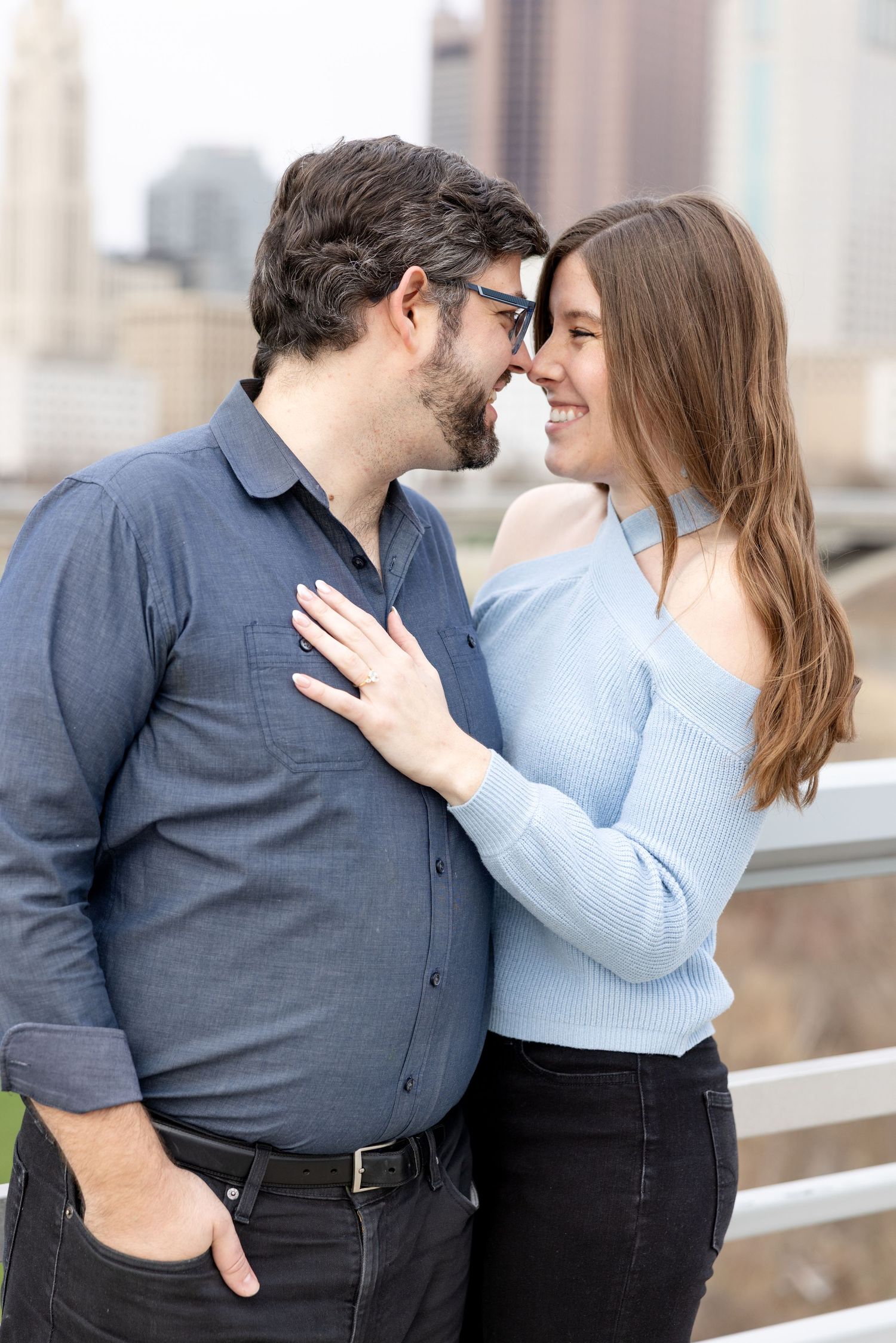 Downtown Columbus engagement photos on Main Street Bridge with a joyful couple in a light and airy style