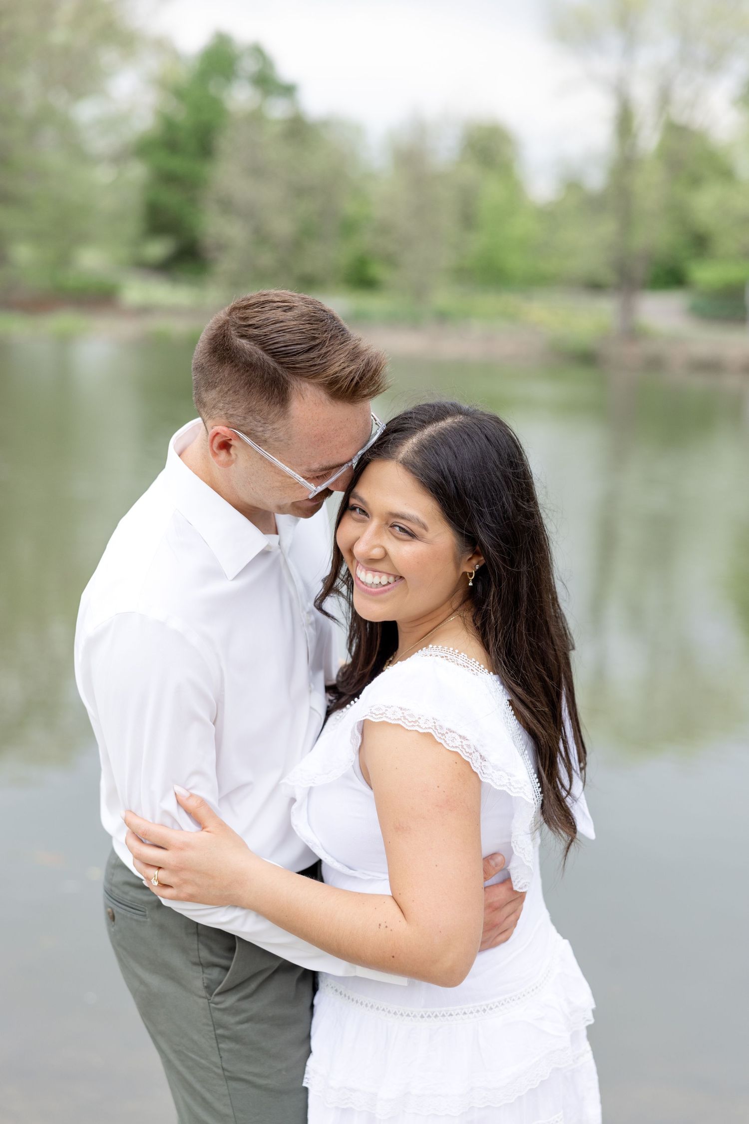 Engaged couple laughing together at Cox Arboretum in Dayton, Ohio during a joyful garden engagement session
