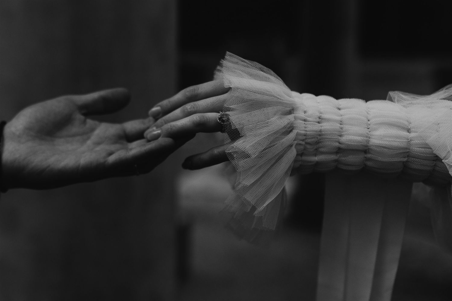 A sequence of black and white photos showing hands carefully arranging papers and documents on a surface.