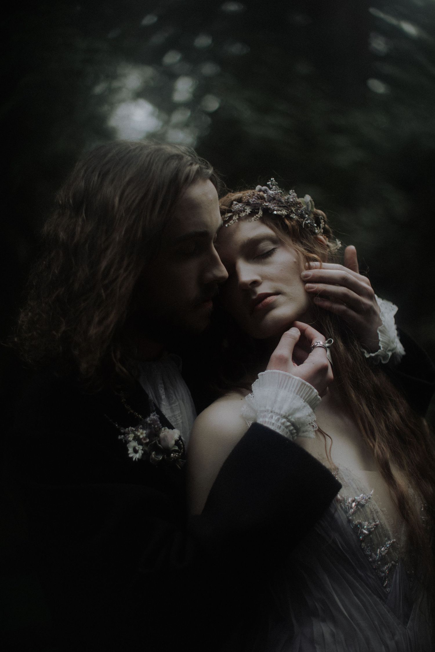 Atmospheric dark portraits showing romantic embrace with delicate crown details captured by a destination elopement photographer.