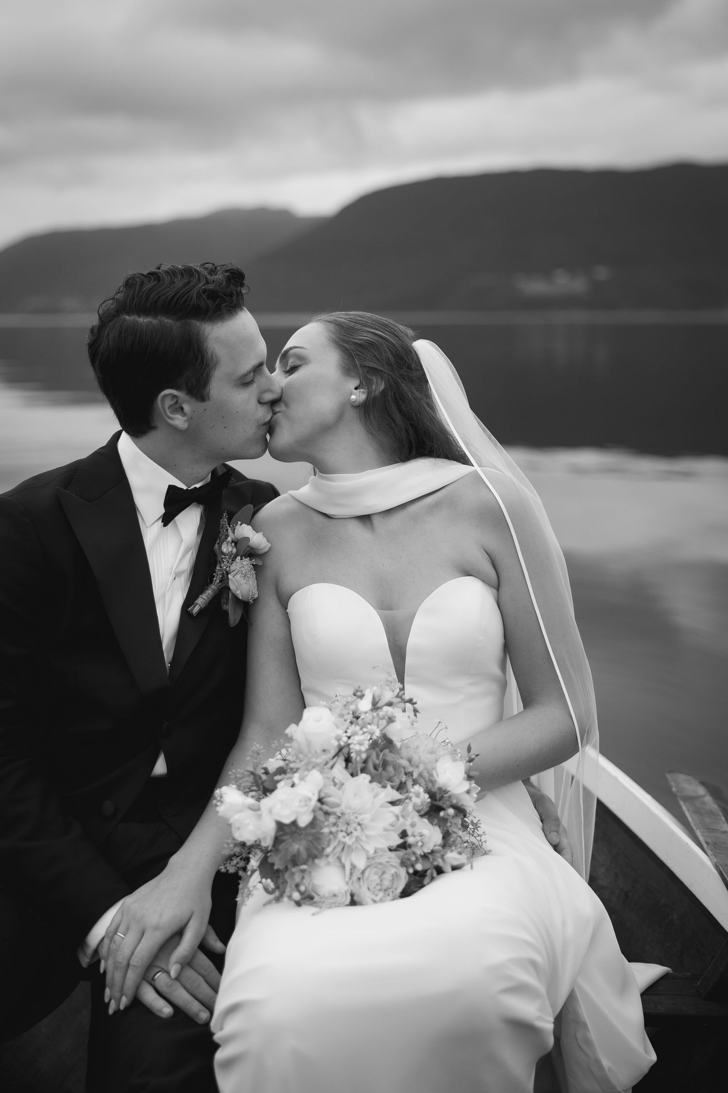 A romantic lakeside wedding photoshoot sequence showing tender moments between the couple with mountains in the background.