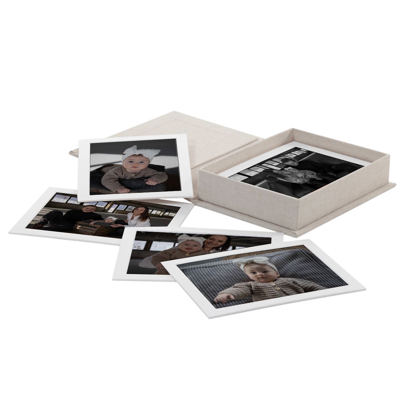 A collection of scattered black and white polaroid photos on a plain white surface.