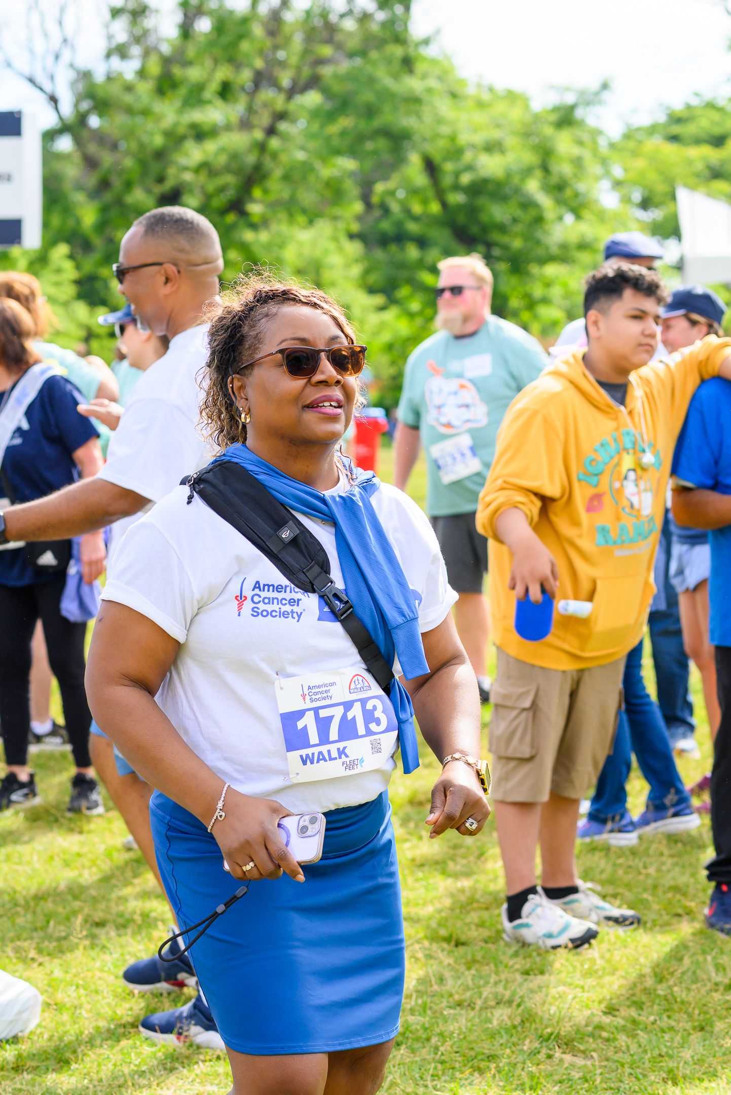 Woman wearing bib number 1713 walks at an American Cancer Society Walk & Roll charity fundraising event.