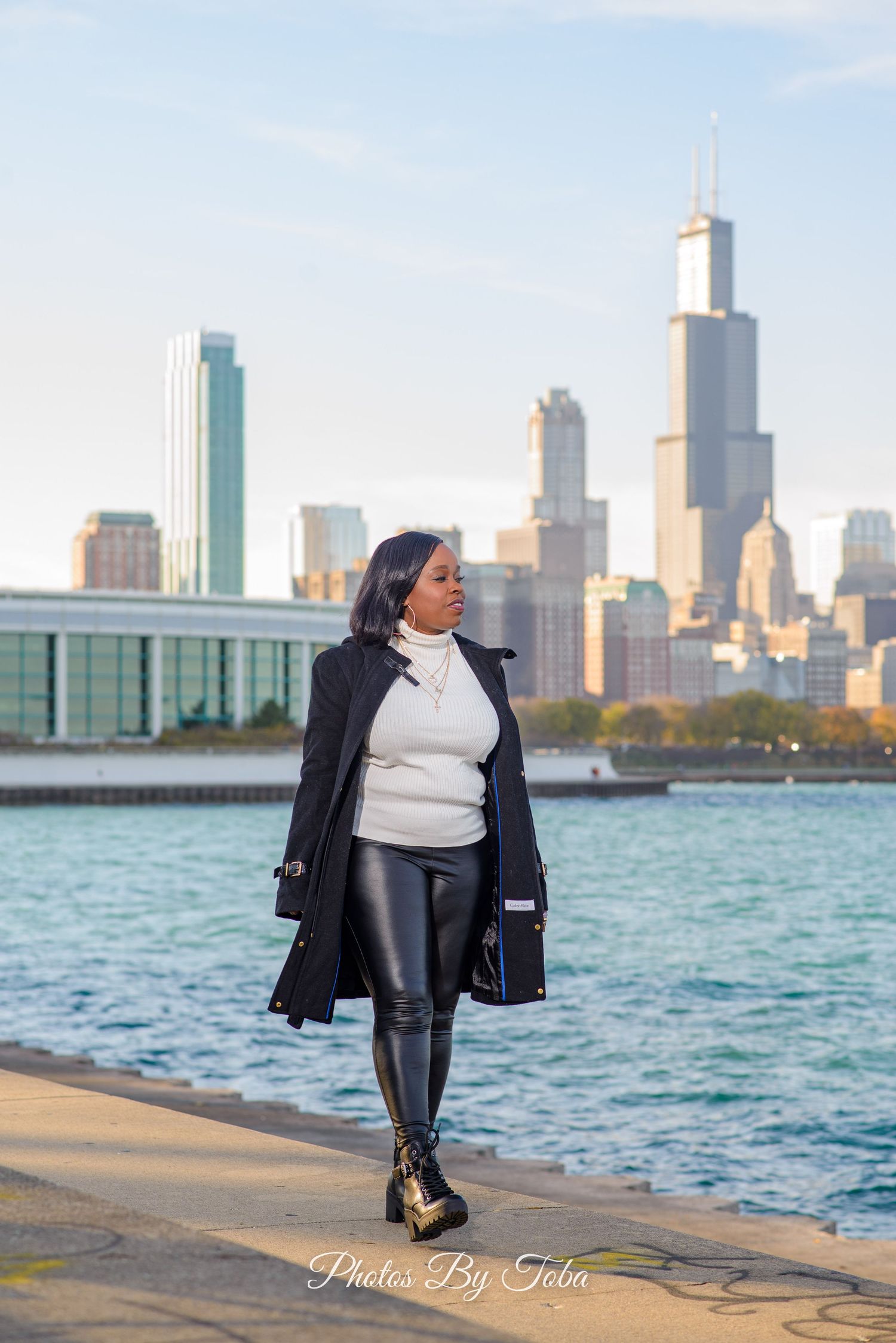 Urban fashion photoshoot with Chicago skyline and Lake Michigan waterfront creating dramatic backdrop at sunset.