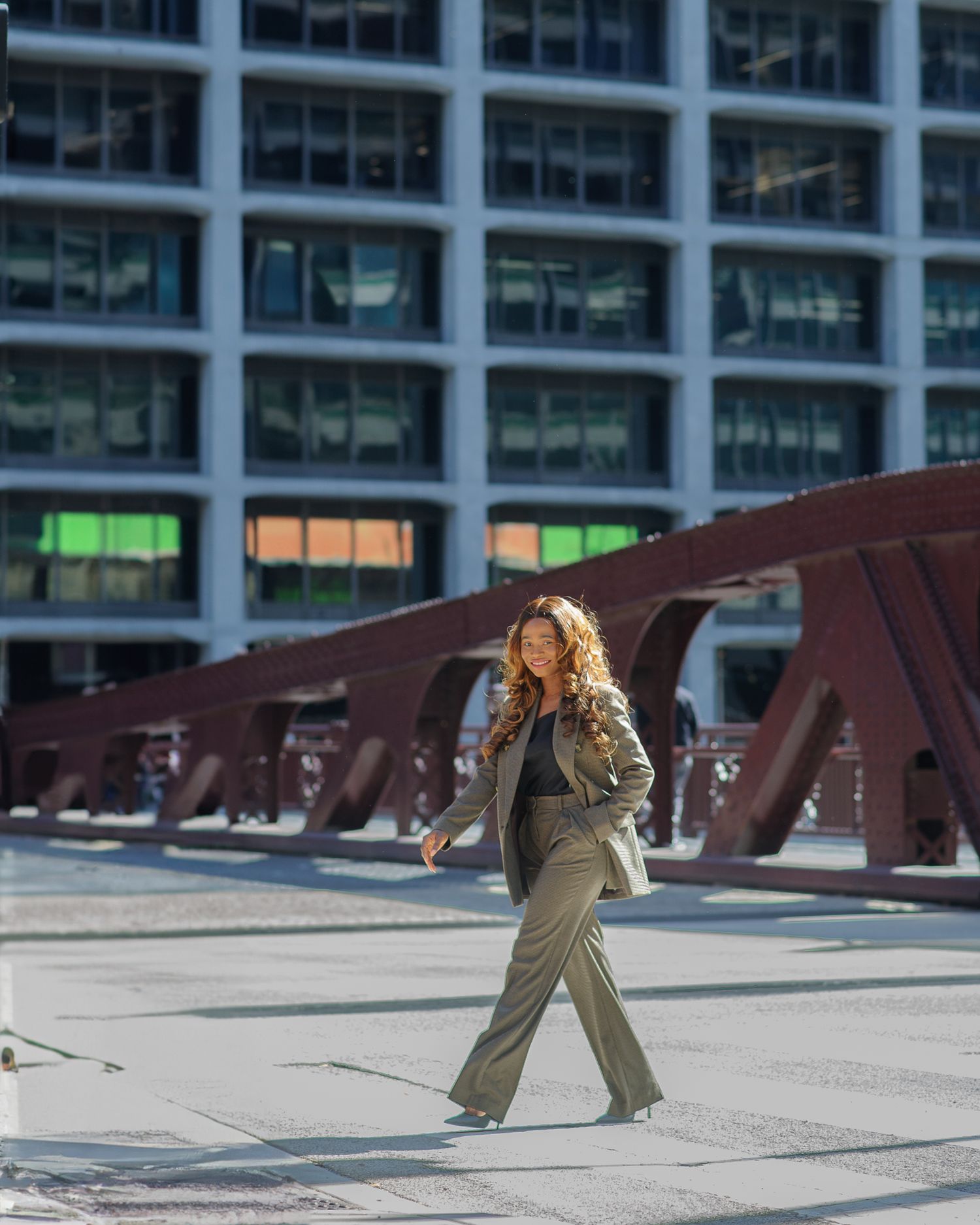 Sequence of walking poses against modern office building facade.