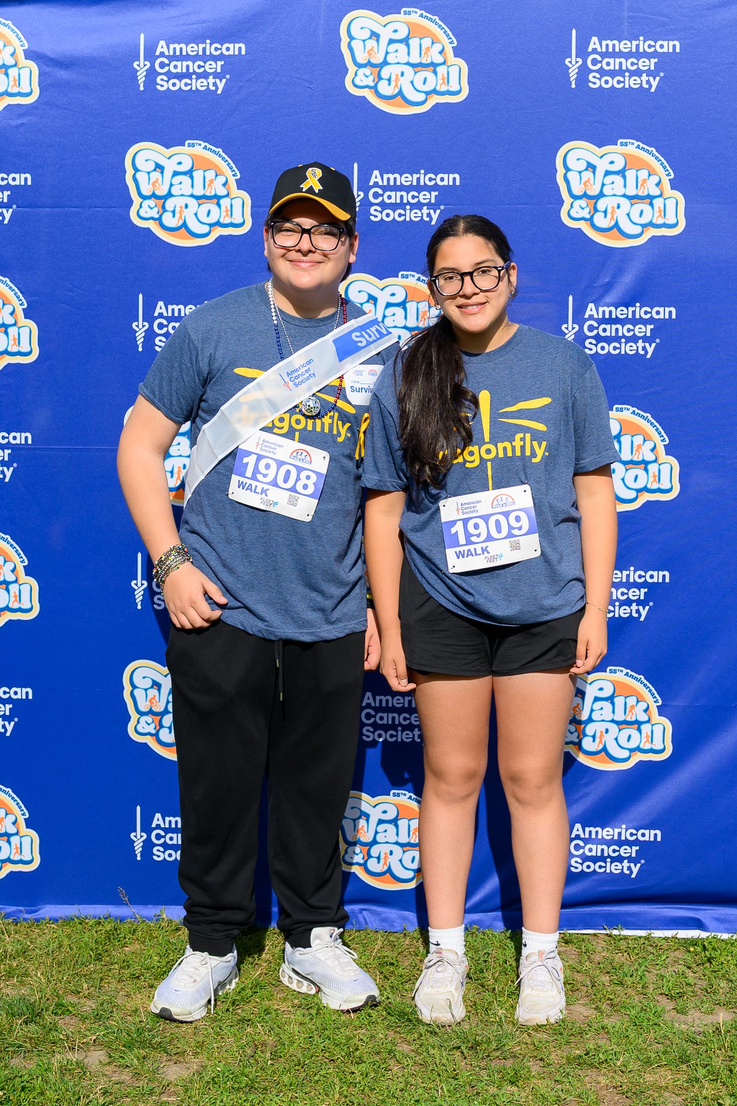 Two participants wearing Dragonfly team shirts and race bibs pose at American Cancer Society Walk & Roll Chicago event.