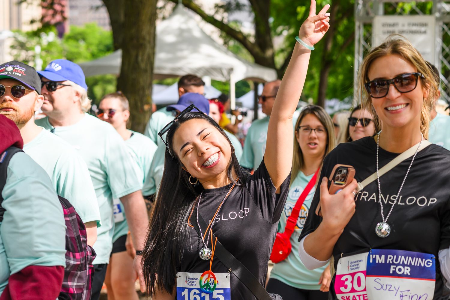 Two women smile and celebrate at the American Cancer Society Walk & Roll Chicago charity race event.