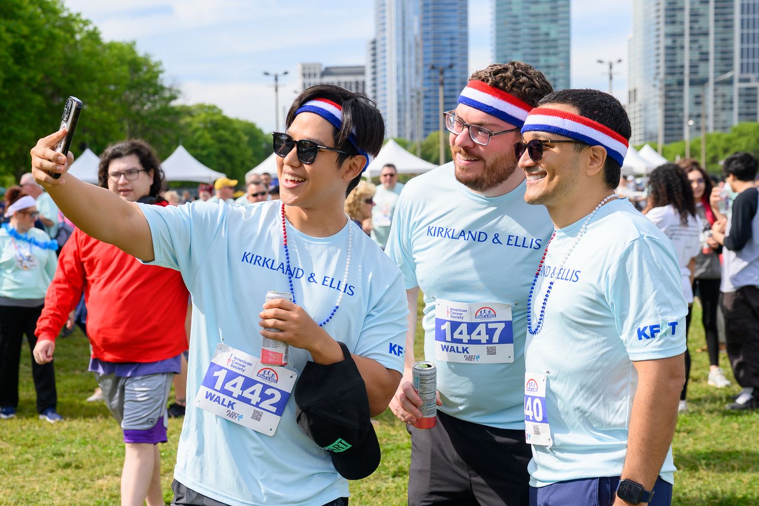 Three men in Kirkland & Ellis team shirts take a selfie at American Cancer Society Walk & Roll Chicago event.