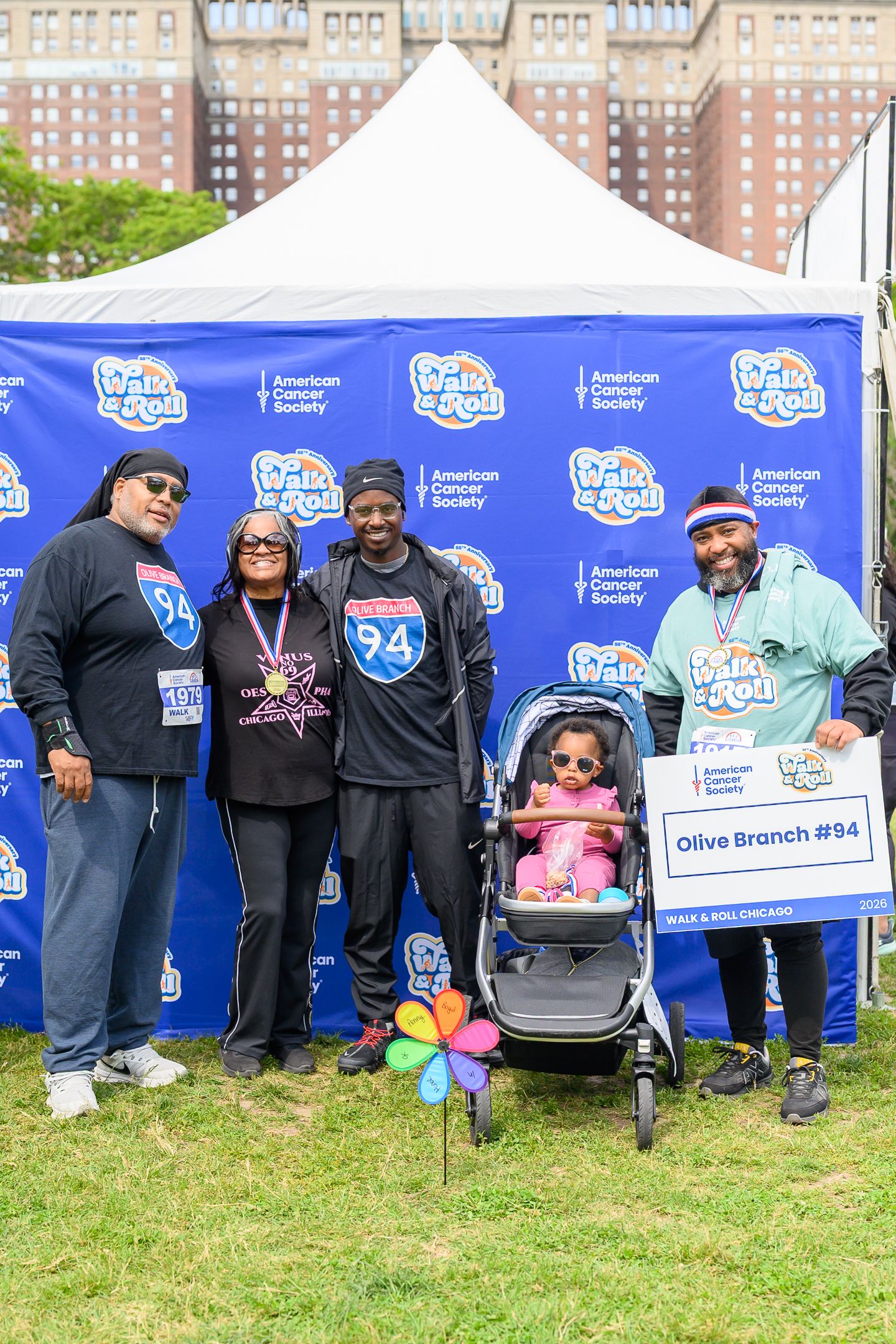 Family group with baby stroller representing Olive Branch #94 at American Cancer Society Walk & Roll event.