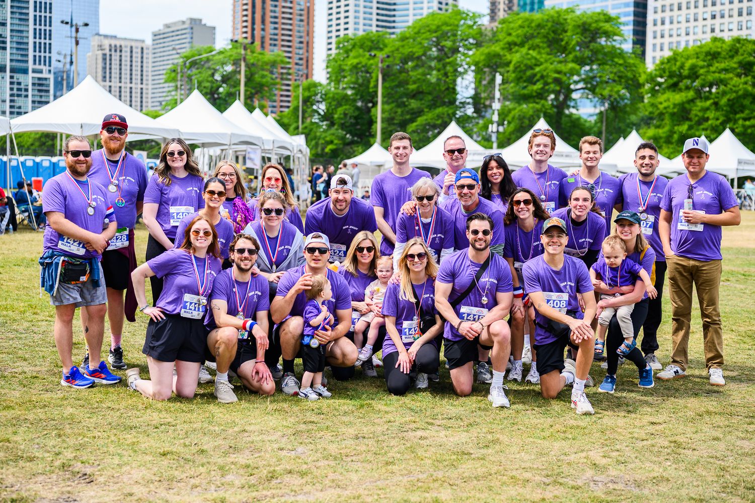 Large group in matching purple shirts poses together at American Cancer Society Walk & Roll Chicago.