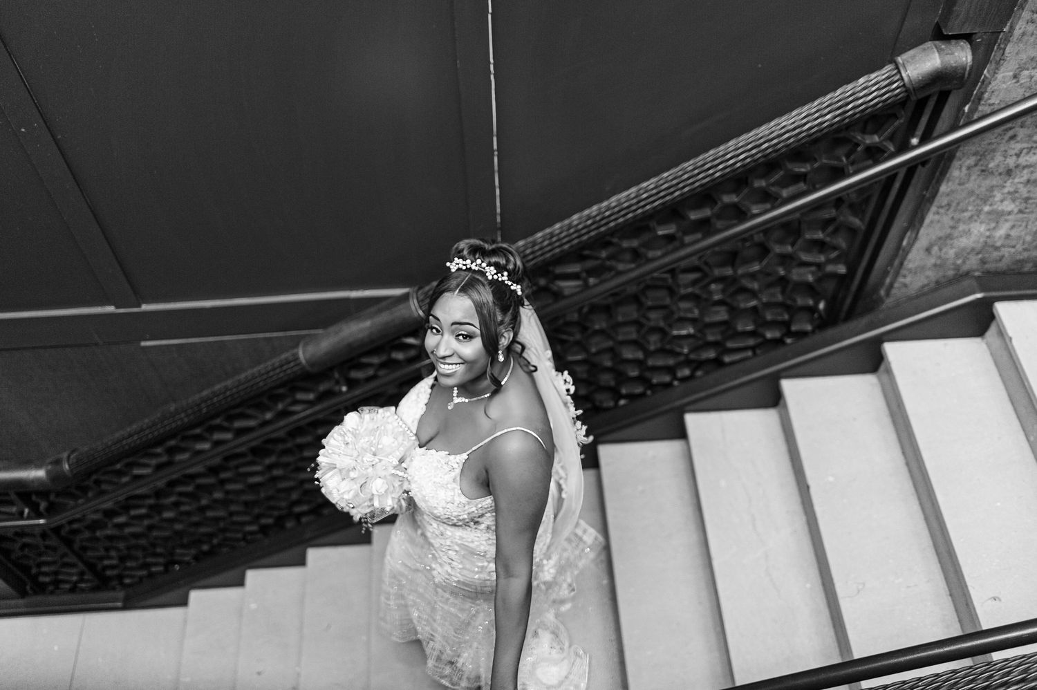 Black and white wedding photos taken on elegant white stairs.