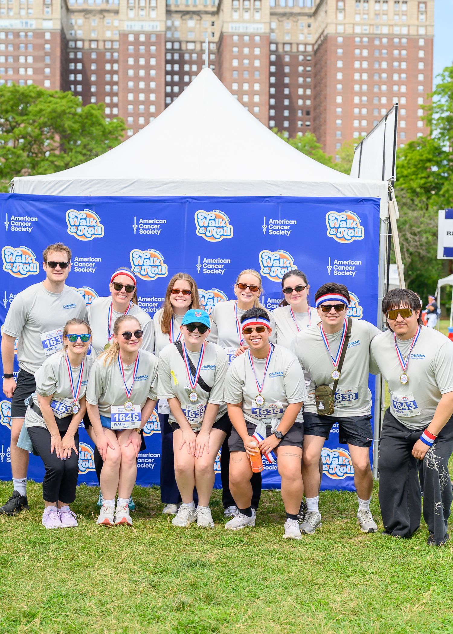 Group of twelve participants pose together at Walk & Roll Chicago American Cancer Society charity event.
