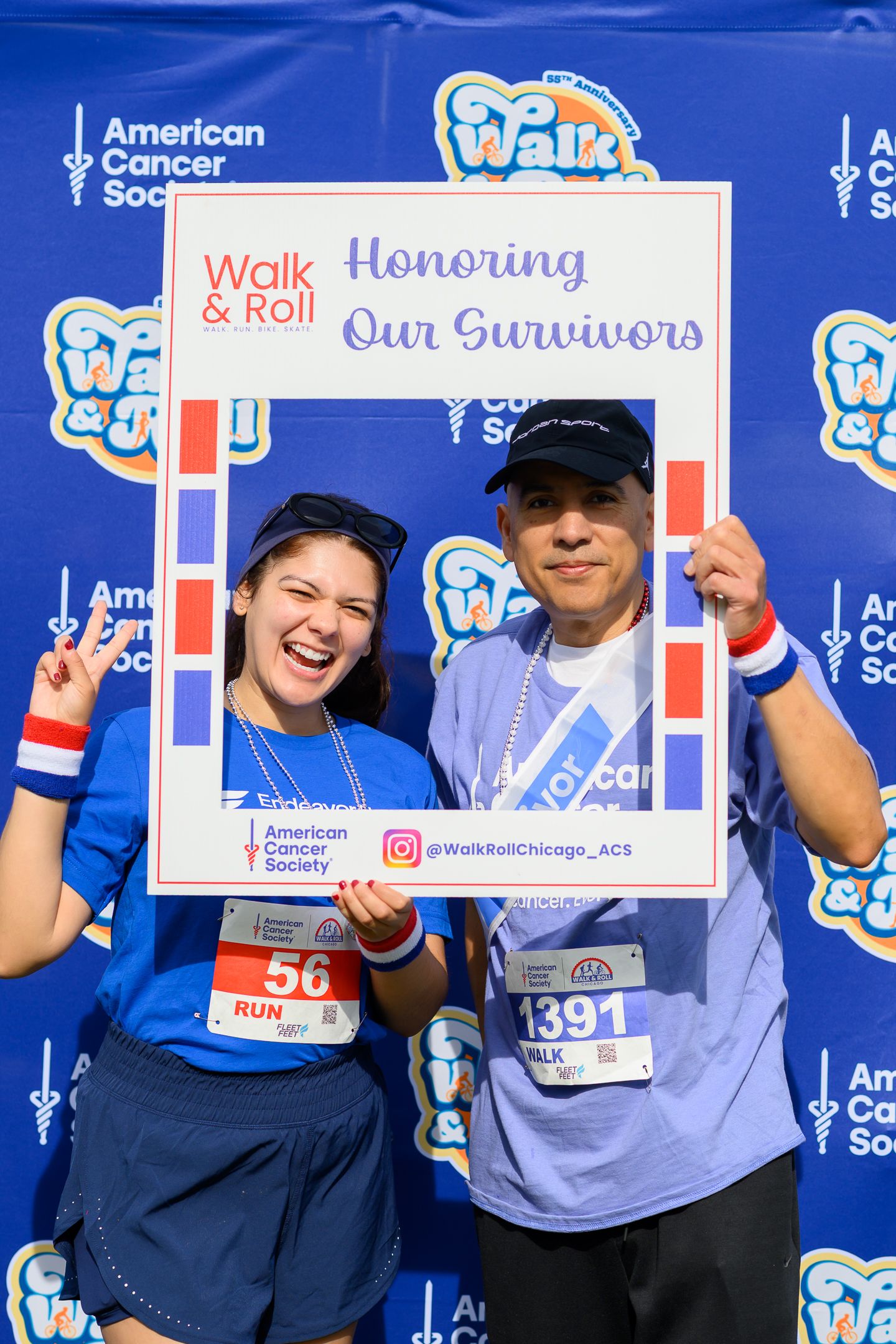 Two participants hold Honoring Our Survivors frame at Walk & Roll Chicago American Cancer Society event.