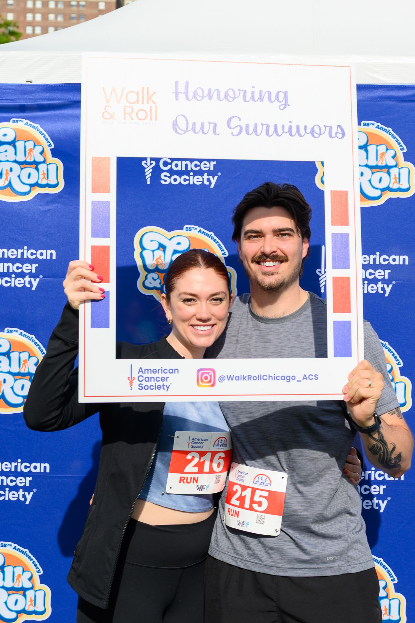 Couple holding Honoring Our Survivors frame at American Cancer Society Walk and Roll Chicago charity event.