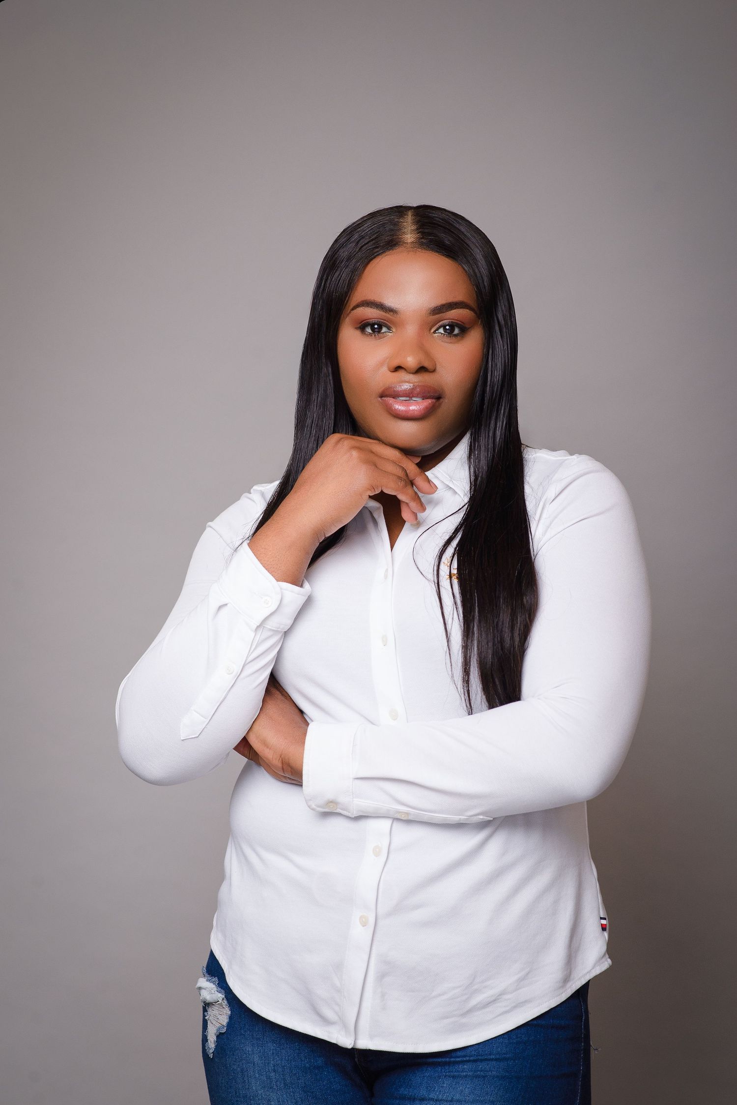 Professional studio portraits showing poses in a white button-down shirt and jeans against a neutral gray backdrop.