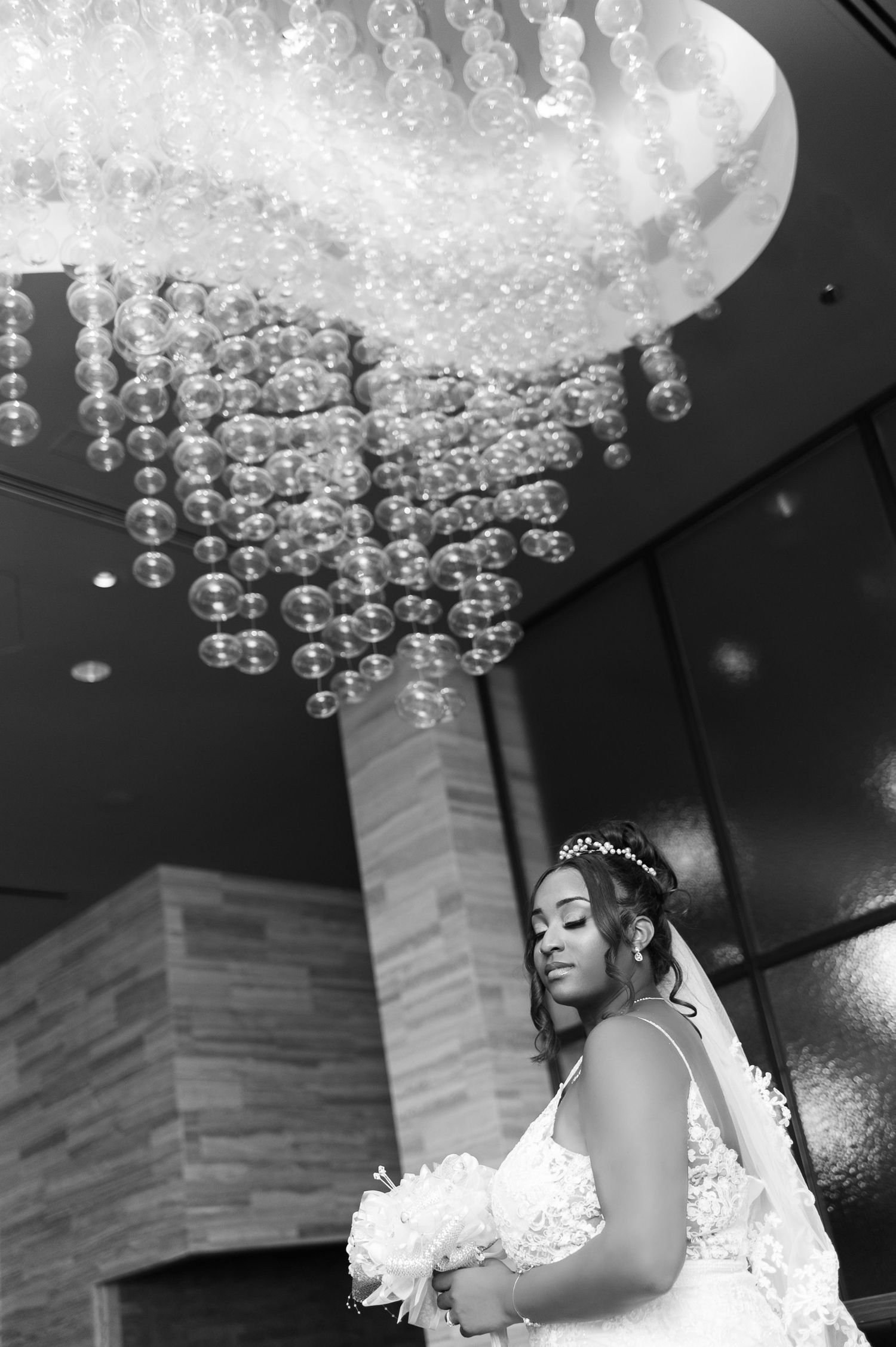 Crystal chandelier creates dramatic lighting for bridal portraits.
