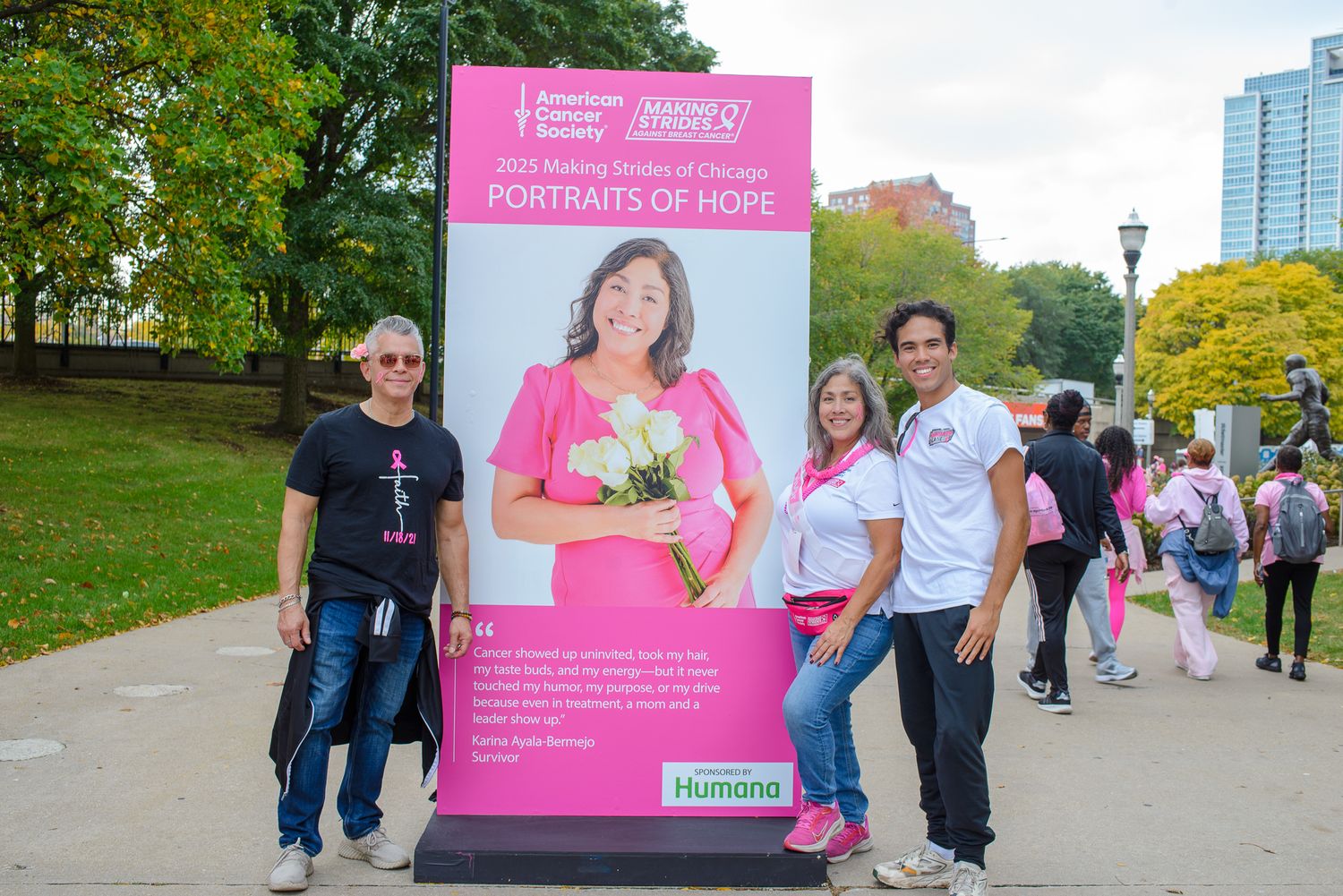 Pink-themed cancer awareness event setup with banners and participants in outdoor setting.